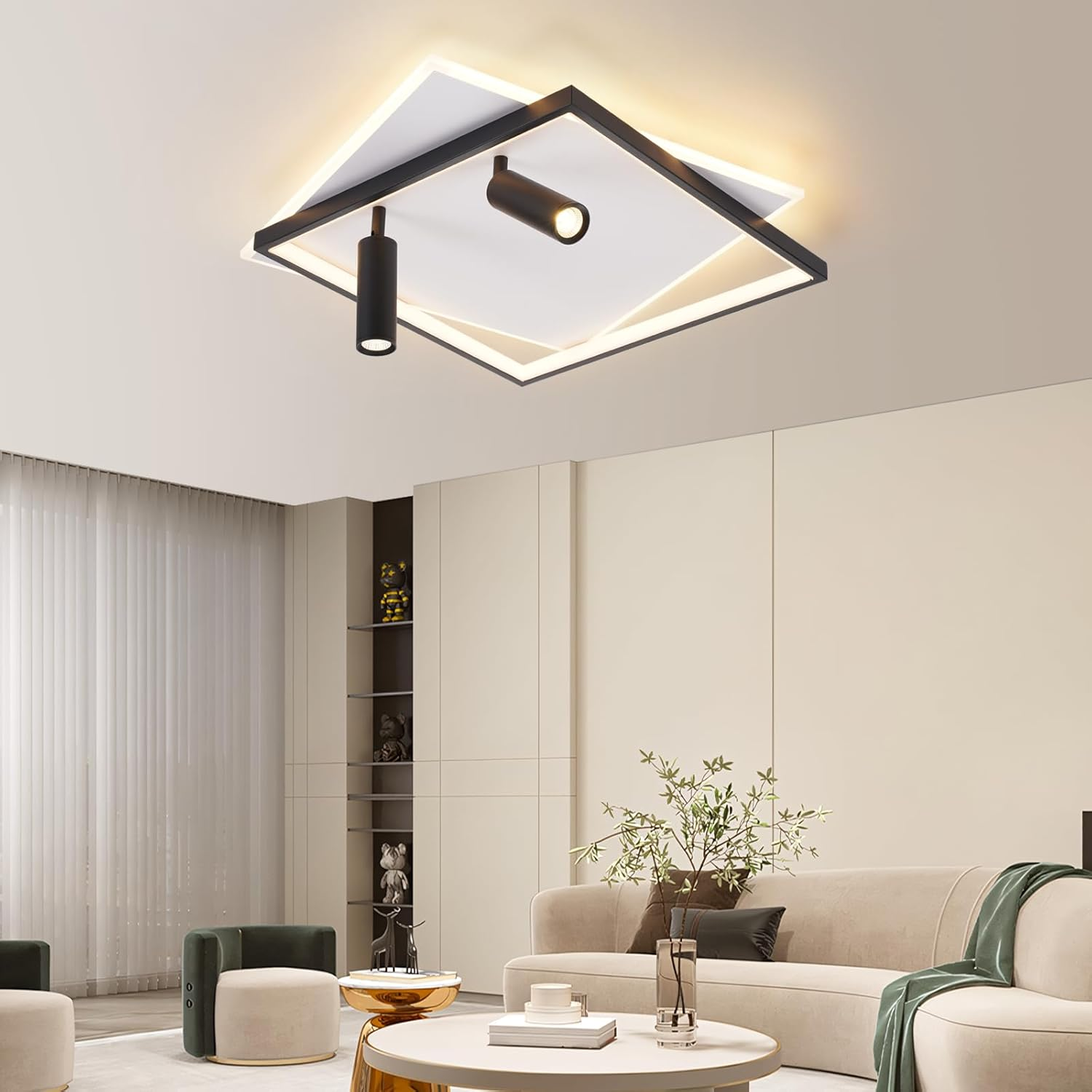 Stanza con pareti bianche, divano e lampada da soffitto con due faretti.