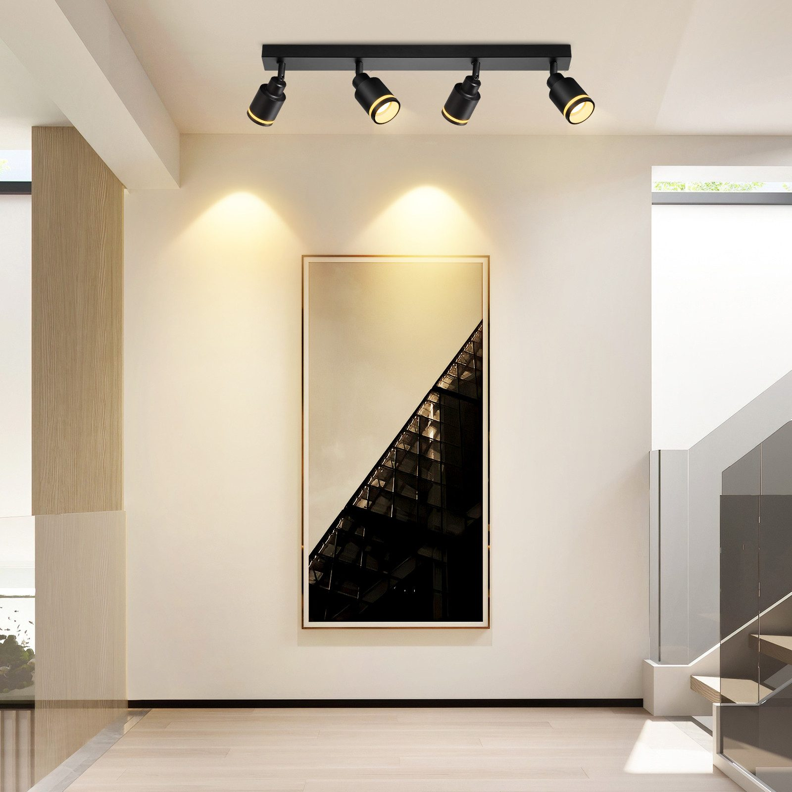Una stanza con un'opera d'arte moderna e faretti a soffitto.