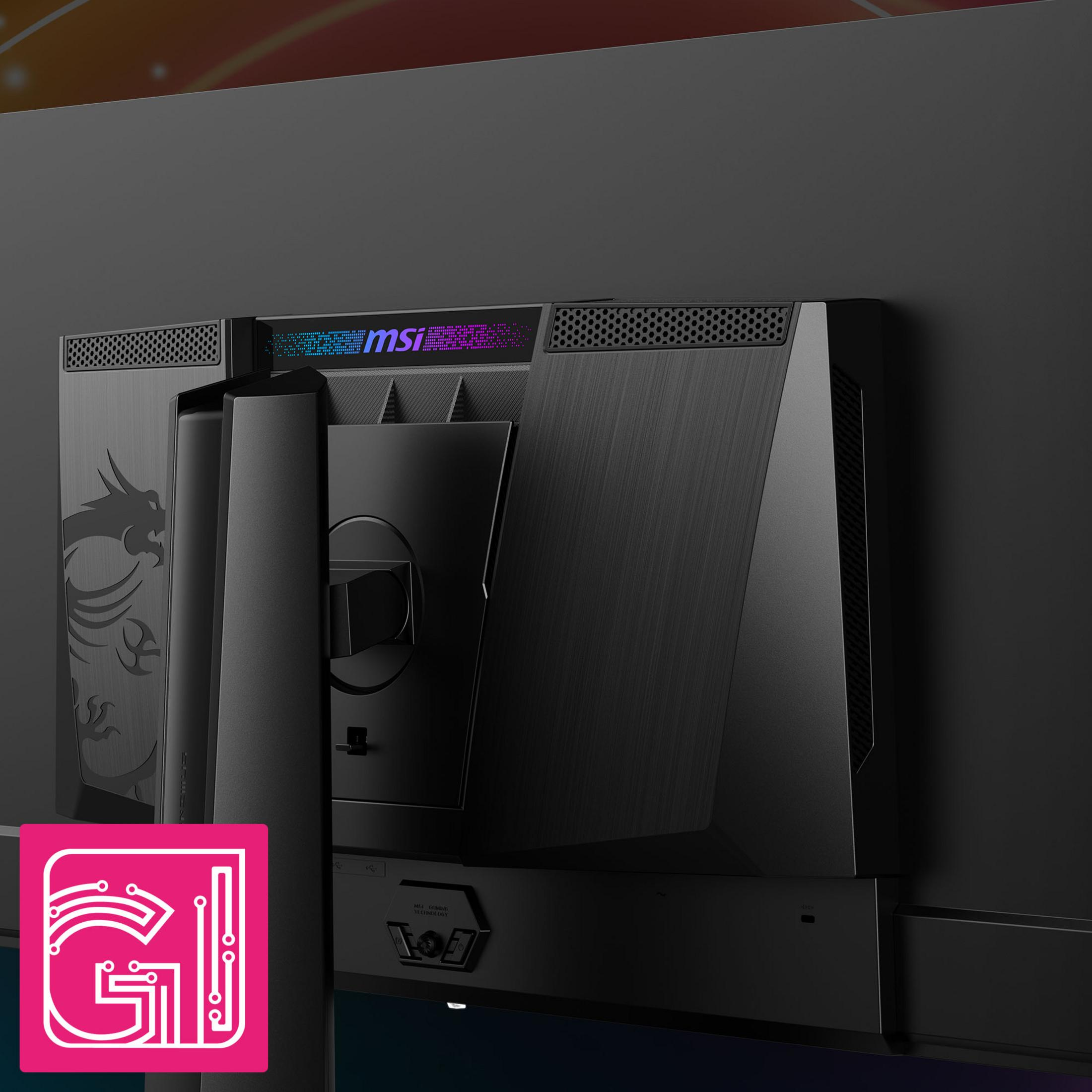 Tył czarnego monitora MSI. Widoczne logo MSI i wzór smoka. Monitor stoi na czarnej powierzchni.