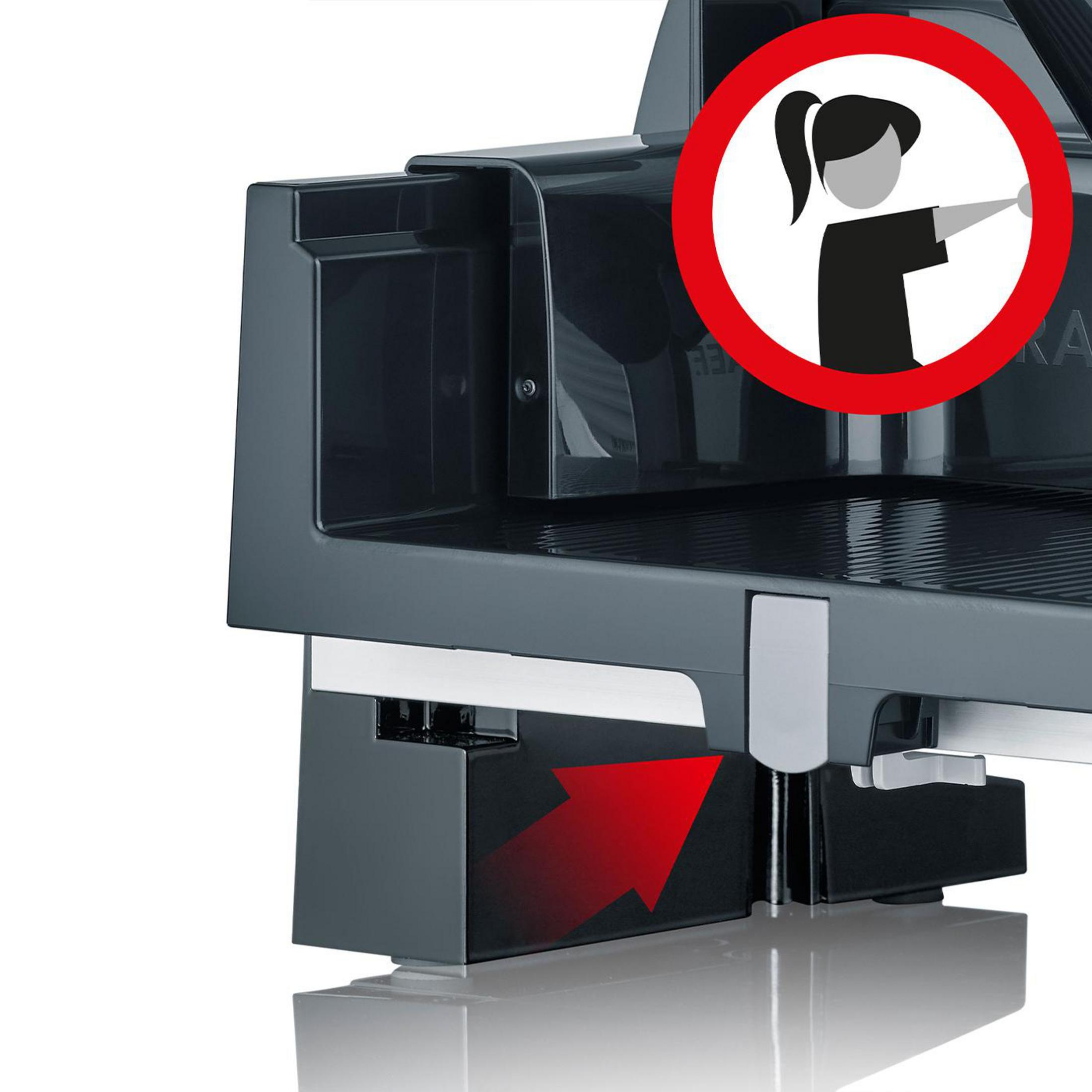 Krajalnica z ostrzeżeniem dotyczącym bezpieczeństwa: sylwetka osoby z wyciągniętą ręką i czerwonym okręgiem.