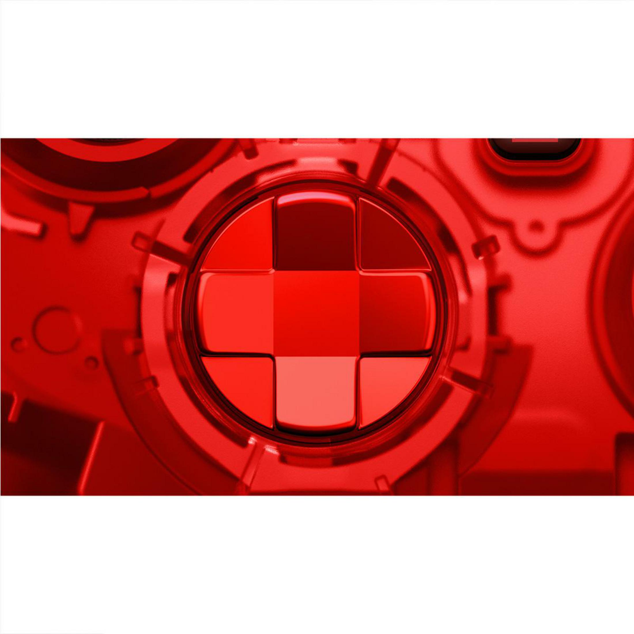 Primer plano del pad direccional rojo en un mando de juego transparente.