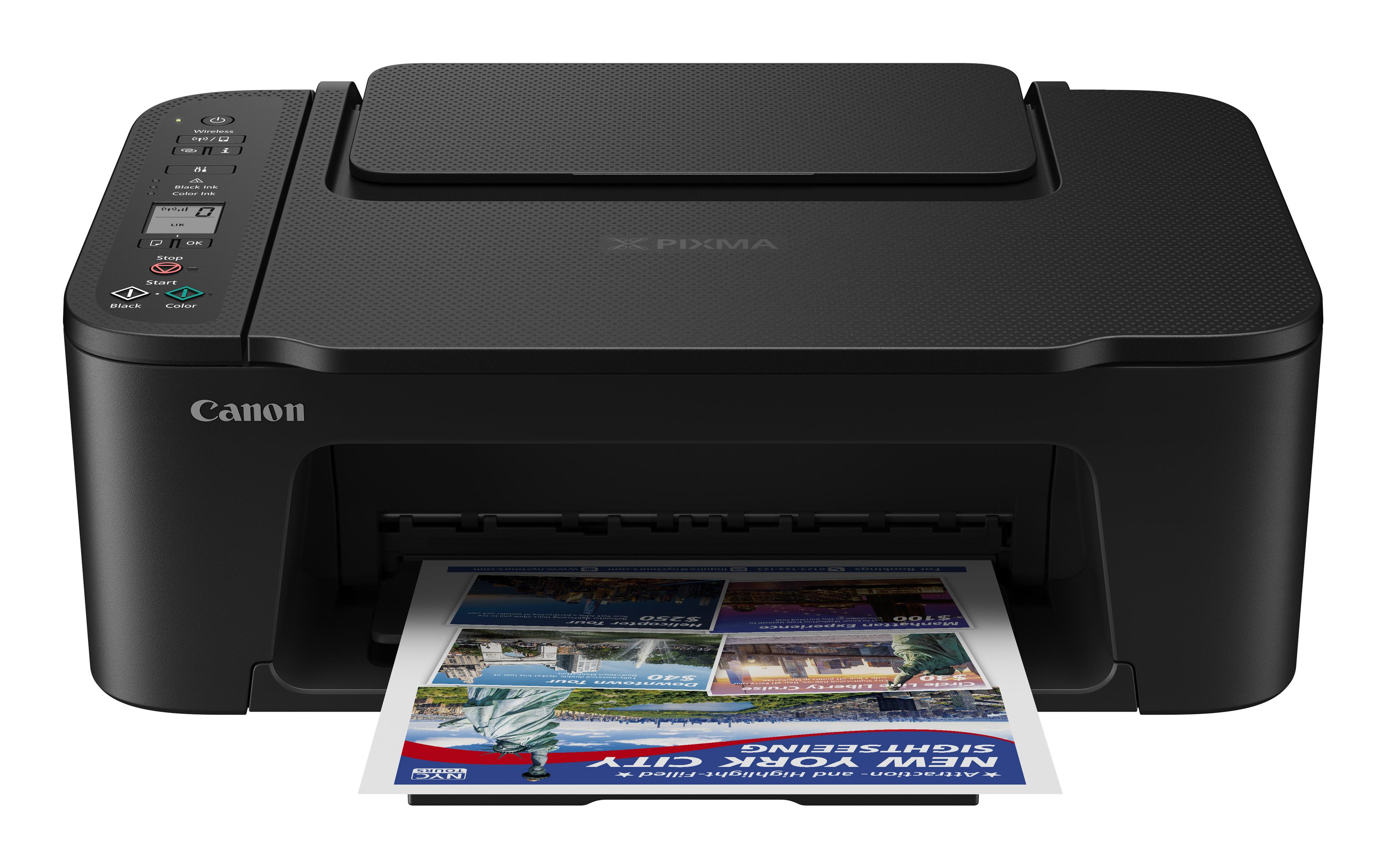 Une imprimante Canon noire imprimant une feuille colorée avec des images et du texte.