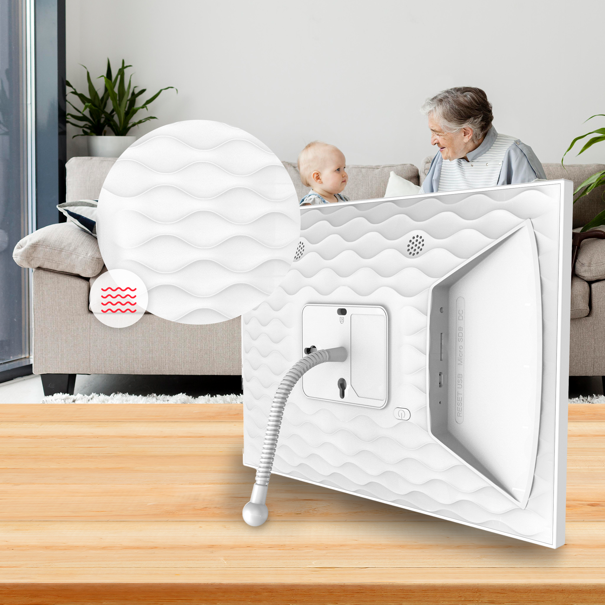 A white digital frame with a baby and woman in the background.
