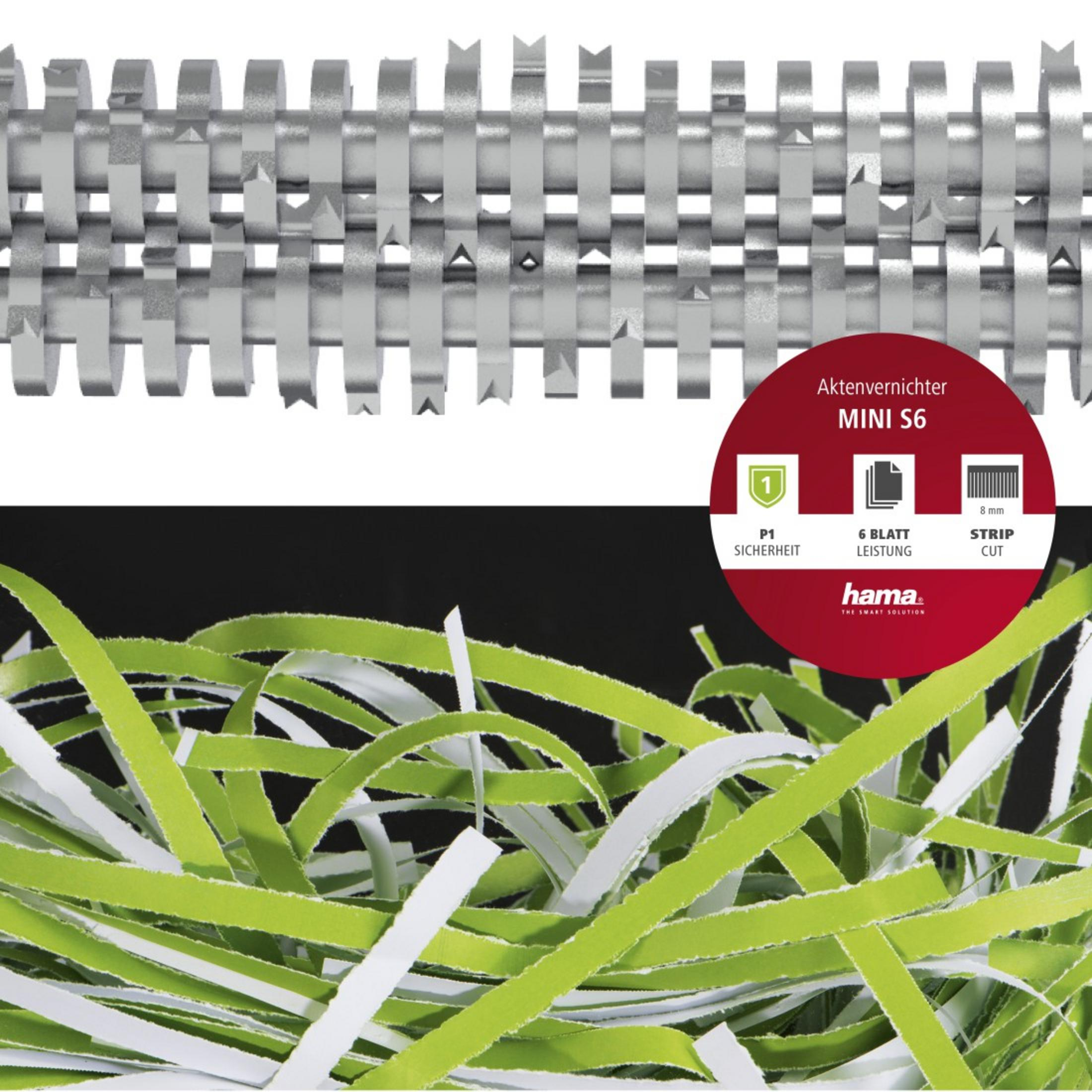 Zbliżenie niszczarki papieru z pociętym zielonym i białym papierem z przodu. Czarne tło.