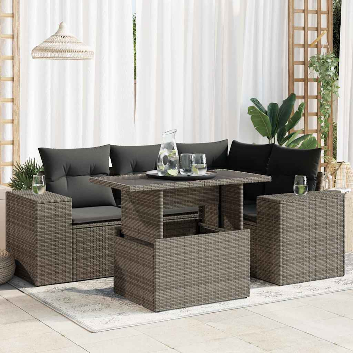 Rattan-Terrassenset mit Tisch, Sofa und Gläsern.
