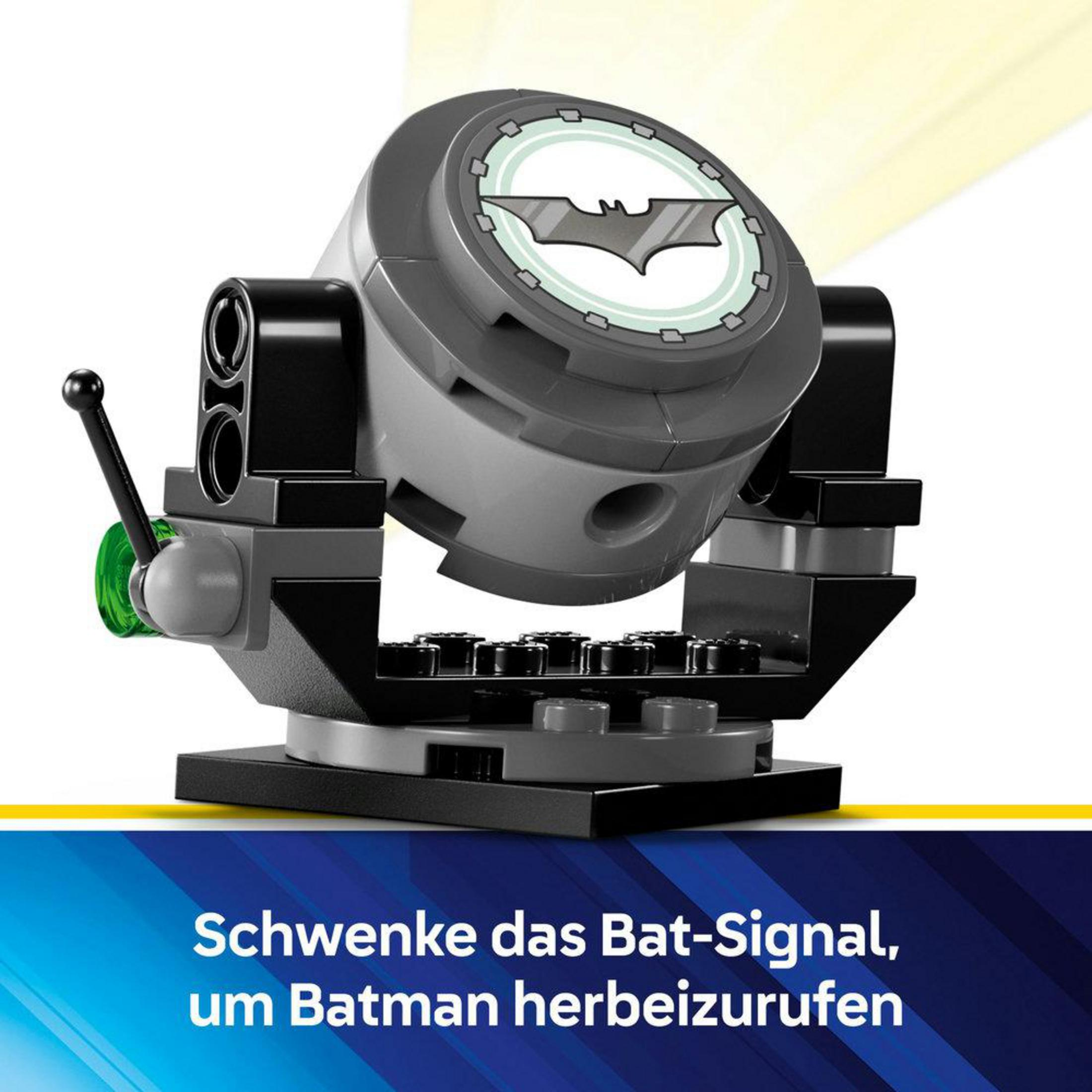 Reflektor Bat-Signal LEGO Batman, szary z logo nietoperza, na czarnej podstawie, z zielonym światłem.