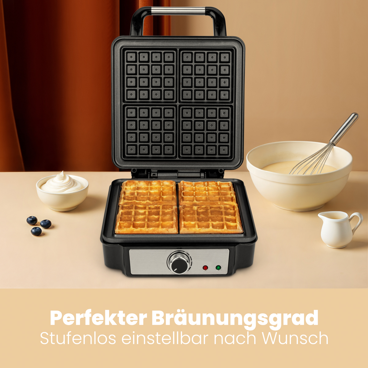 Gofry w gofrownicy, miski ze śmietaną i ciastem, jagody.