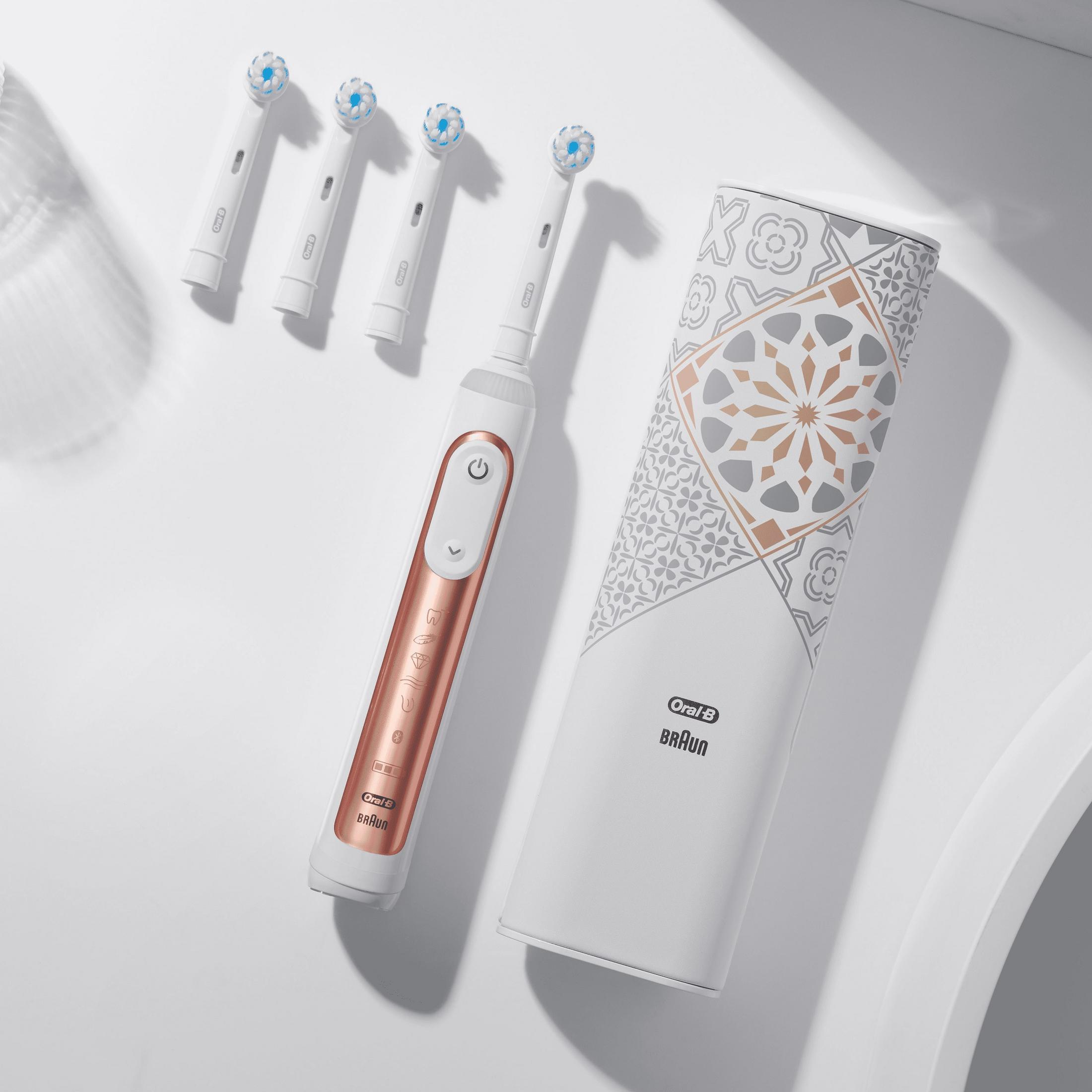 Brosse à dents électrique avec plusieurs têtes et un étui de chargement.