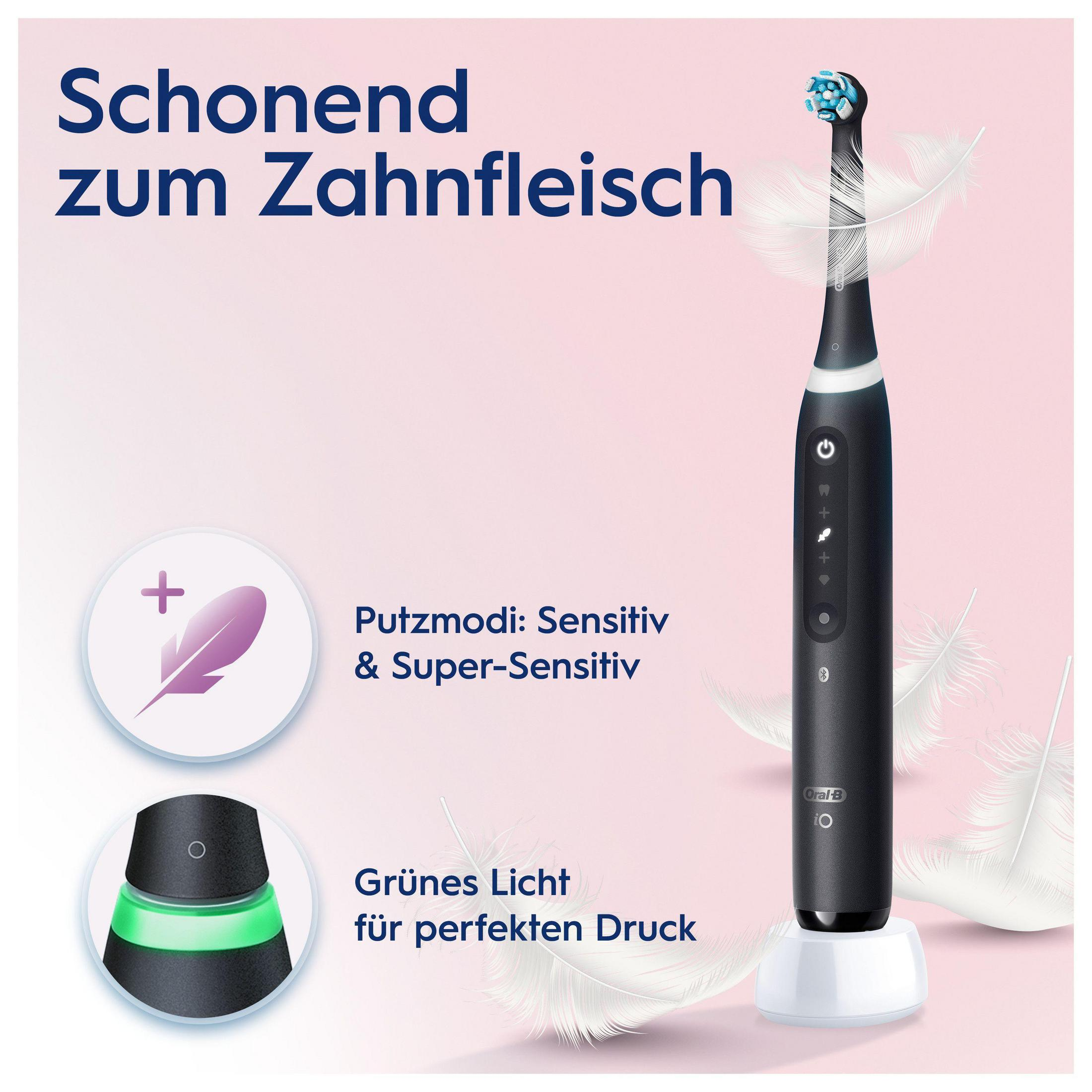 Eine schwarze elektrische Zahnbürste mit deutschem Text und weißen Federn an der Seite.