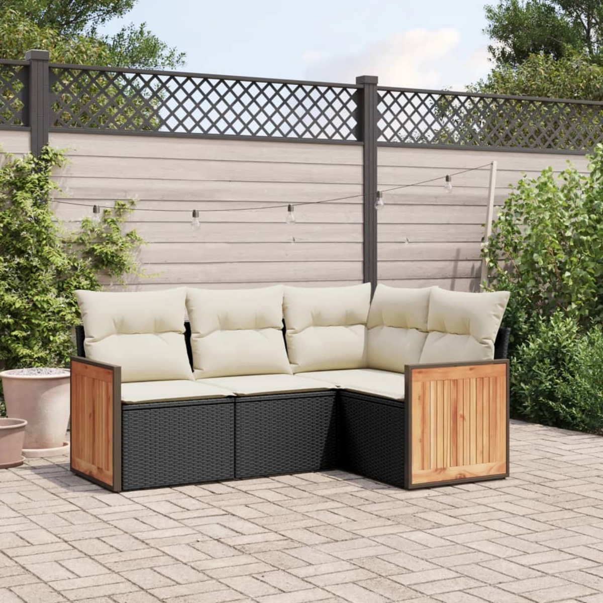 L-förmiges Outdoor-Sofa mit cremefarbenen Kissen, schwarzem Korbgeflecht und Holzakzenten, auf einer Terrasse.