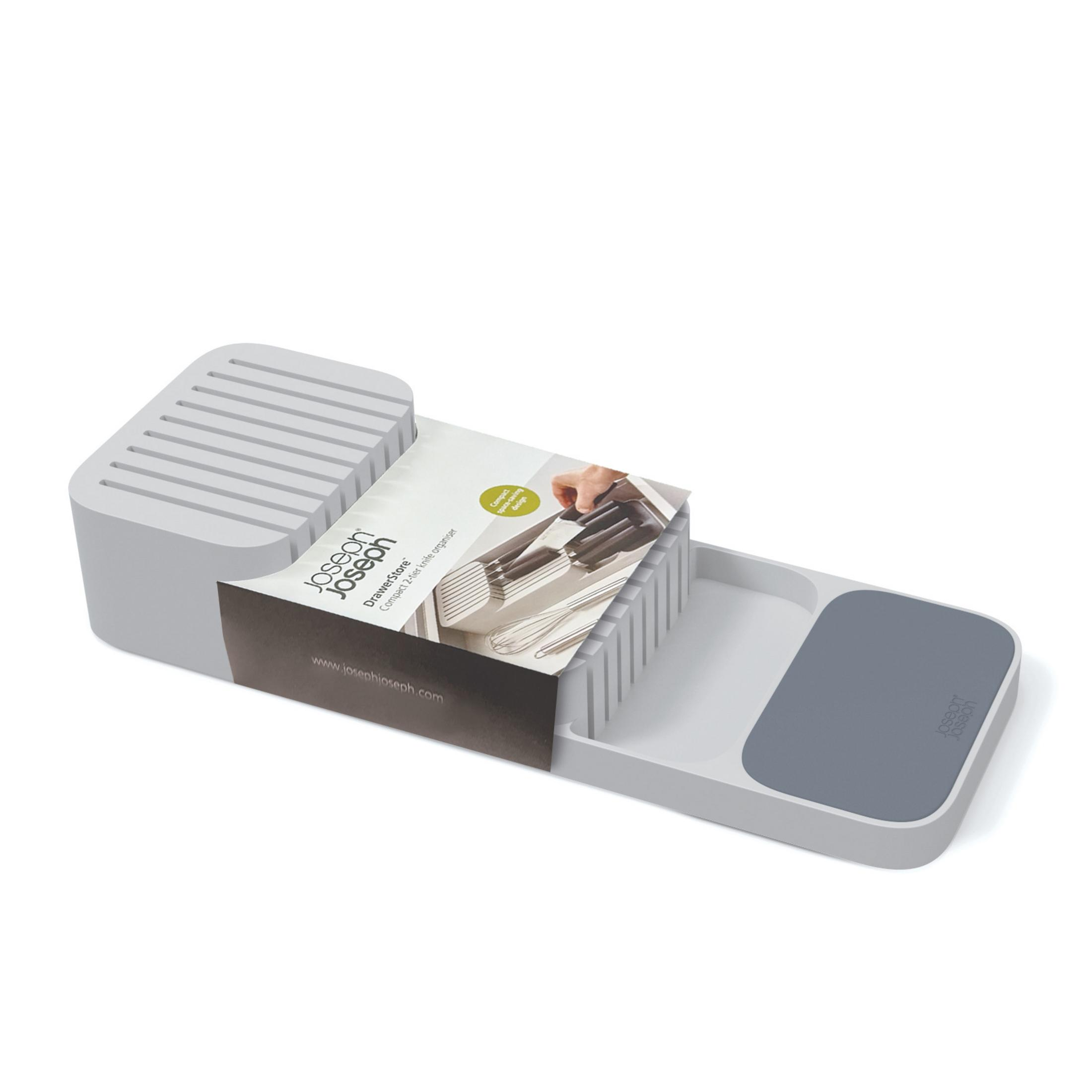 Organizador de cuchillos gris con embalaje, compartimentos para cuchillos y una bandeja pequeña.