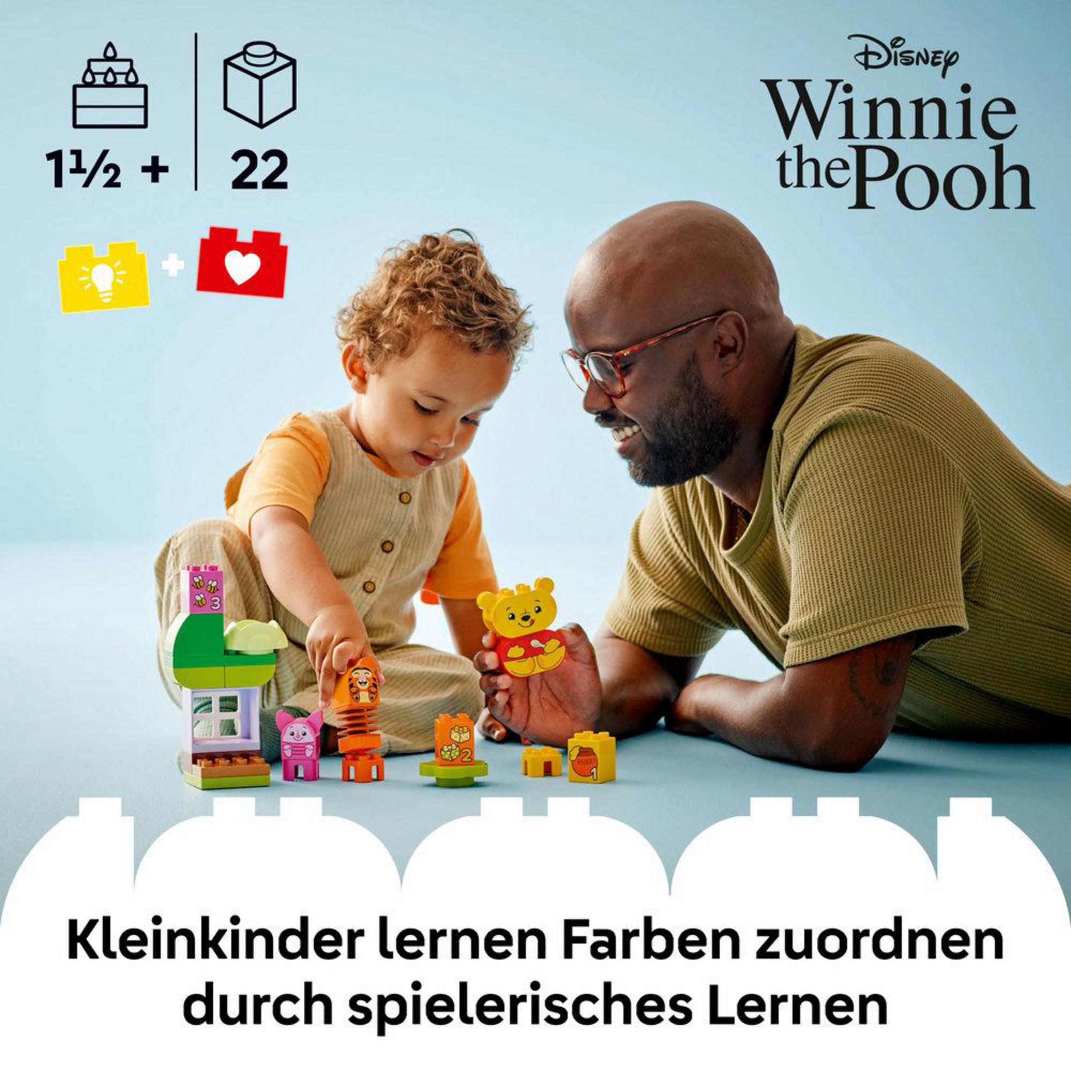 Un padre y un niño juegan con un set LEGO Duplo Winnie the Pooh. Texto en alemán en la parte inferior.