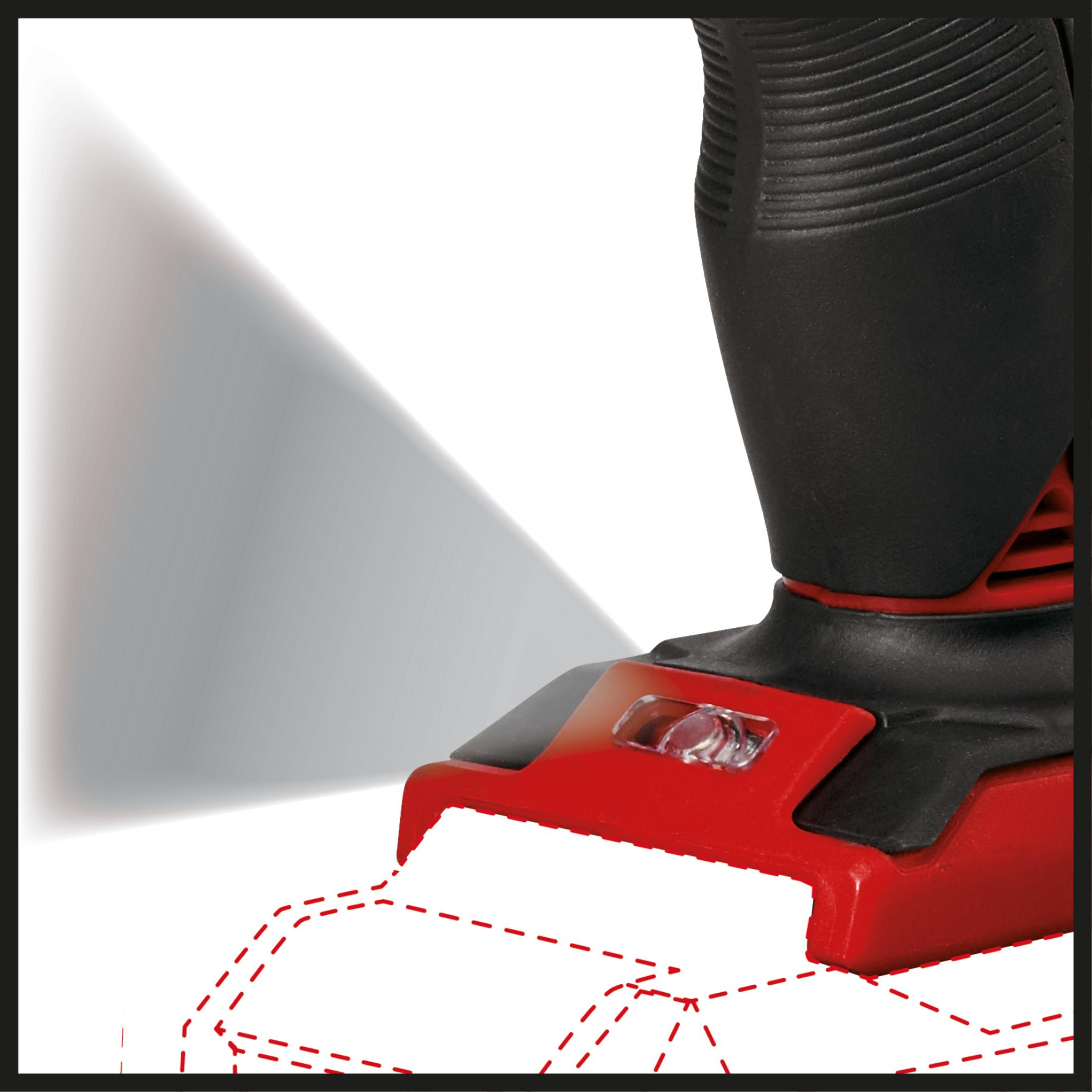 Zbliżenie czarno-czerwonego elektronarzędzia z wiązką światła świecącą na ścianie.