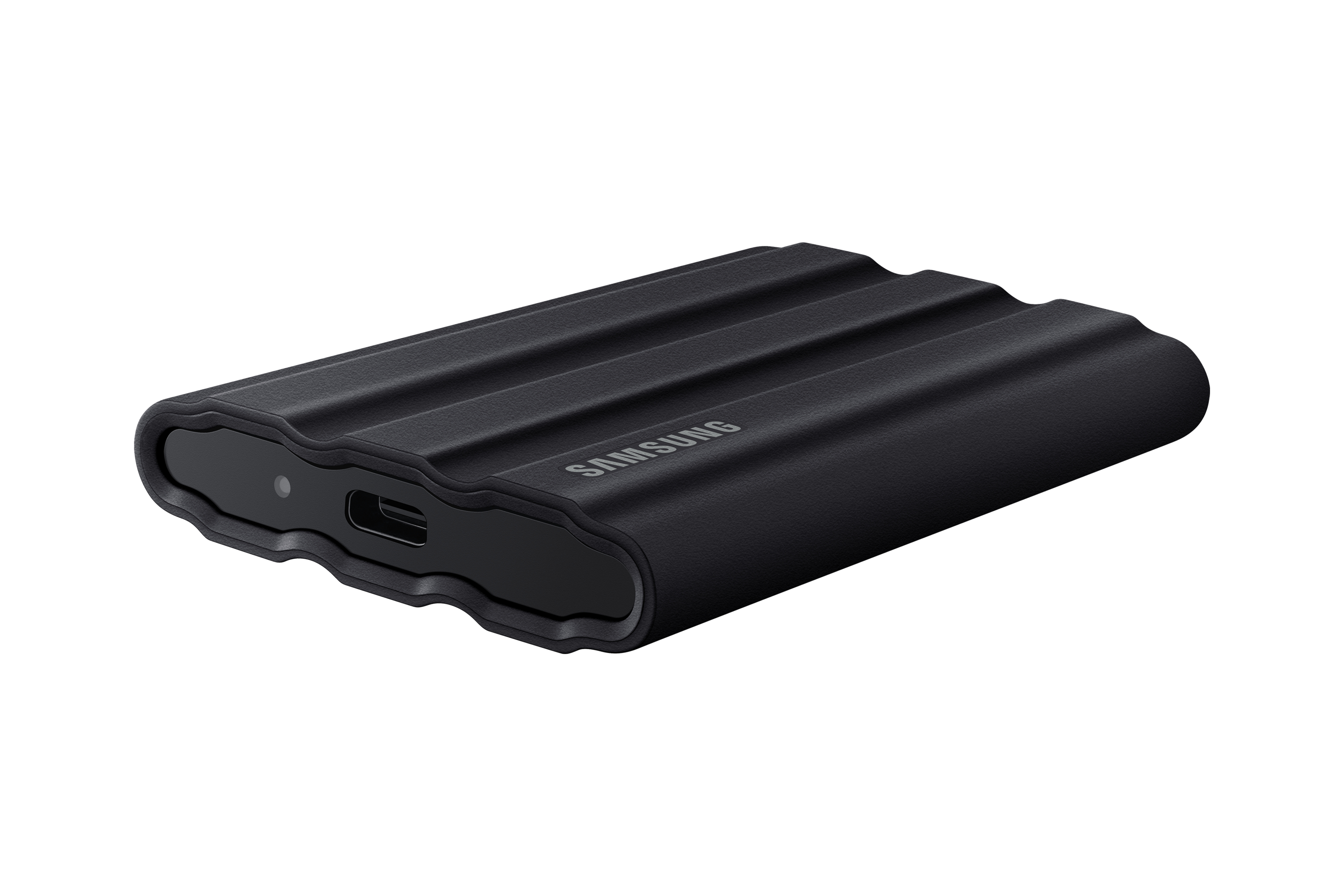 Black Samsung external hard drive. It has a textured surface and a USB-C port. White background.