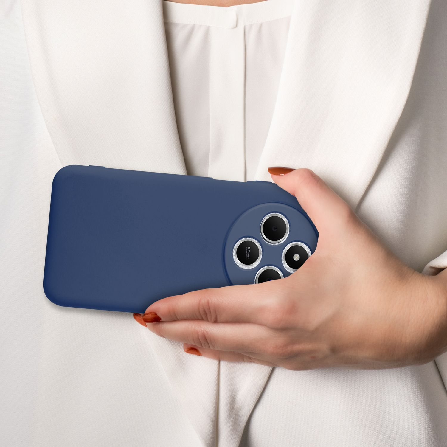 Eine Hand hält ein marineblaues Telefon. Die Person trägt eine weiße Bluse. Die Hülle hat vier Kameralöcher.