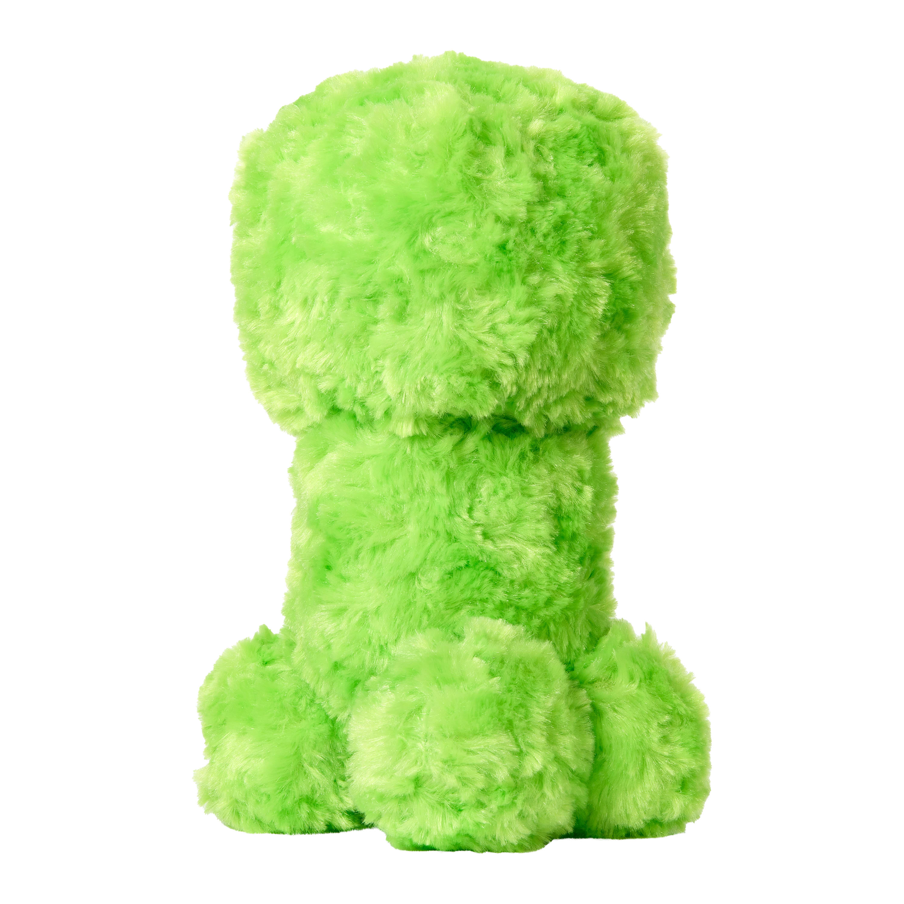 Un peluche verde a forma di creatura a quattro zampe, con testa e corpo quadrati, su sfondo bianco.