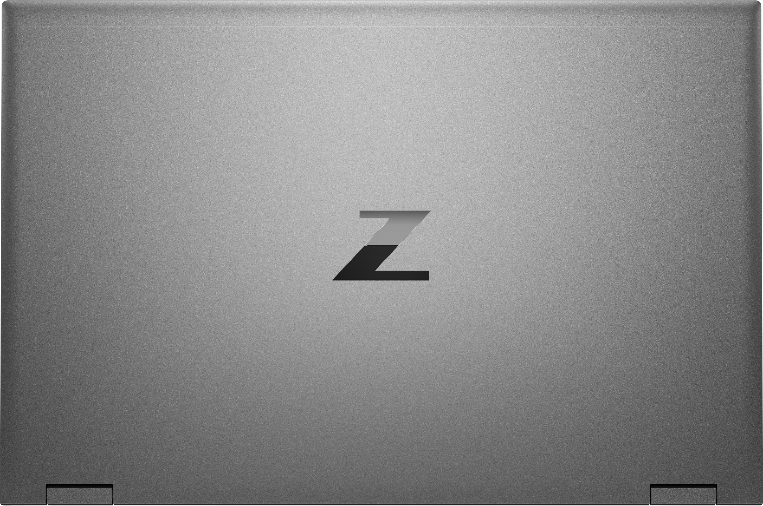Grauer Laptopdeckel mit schwarzem 'Z'-Logo. Laptop ist geschlossen, Hintergrund grau.