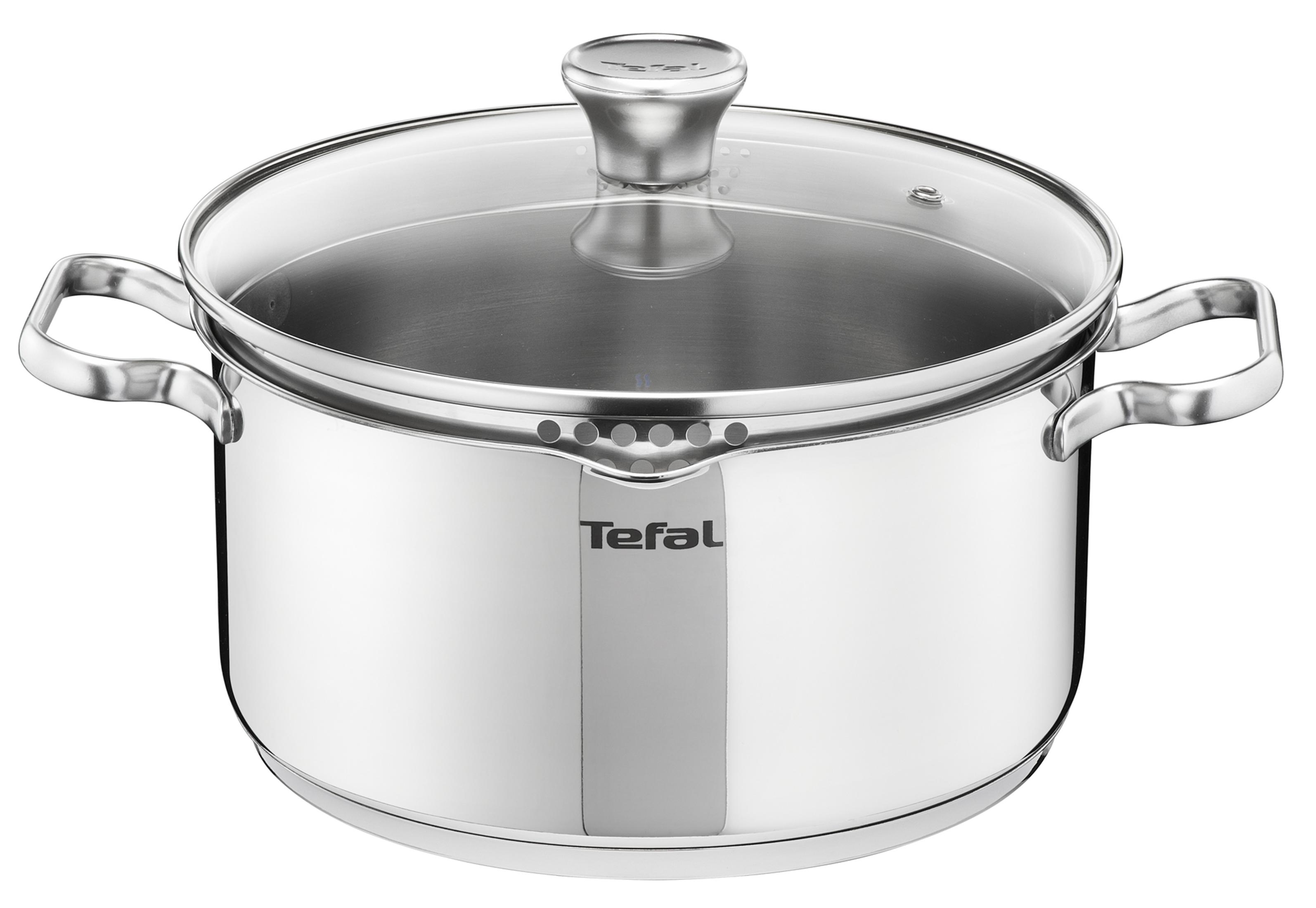 Una olla Tefal de acero inoxidable con tapa de vidrio, sobre un fondo blanco.