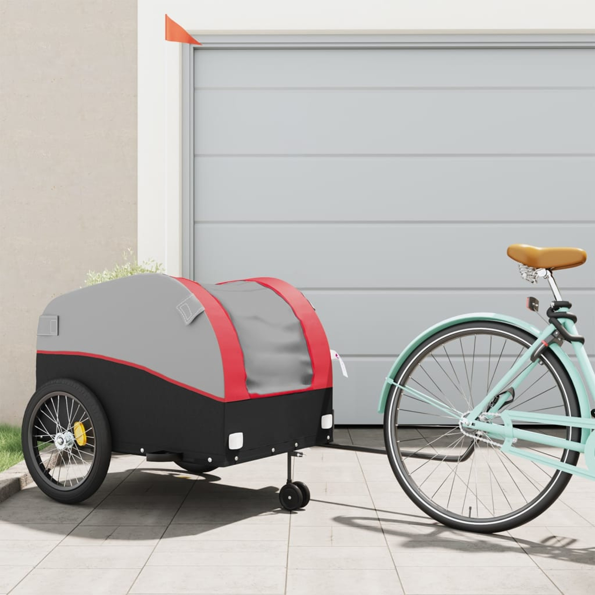 Ein Fahrrad und Anhänger in einer Garage, mit rotem Akzent am Anhänger.