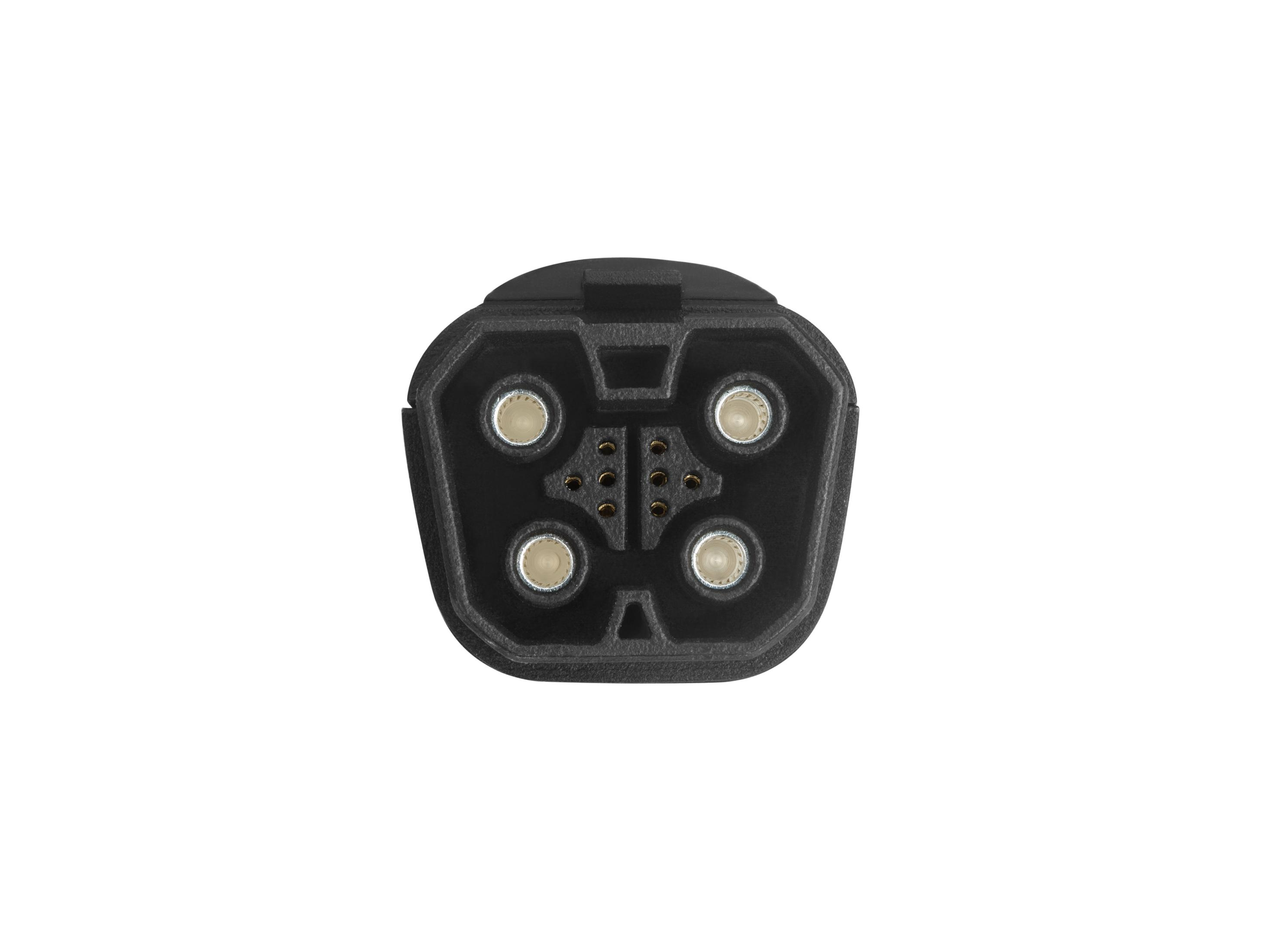 Un conector de cargador EV negro con múltiples pines, visto desde arriba.