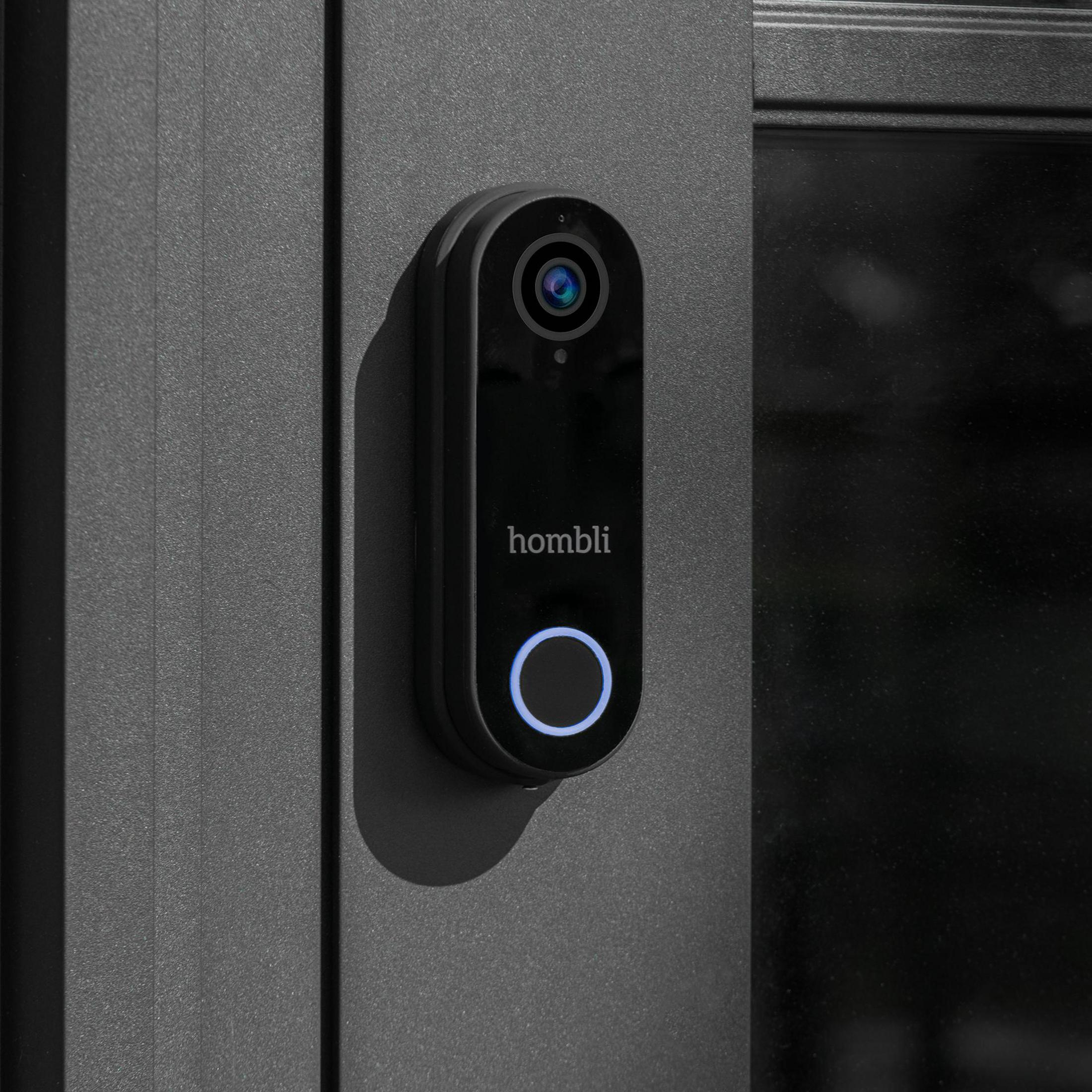 Campanello nero 'Homli' su una porta grigio scuro con anello luminoso blu.