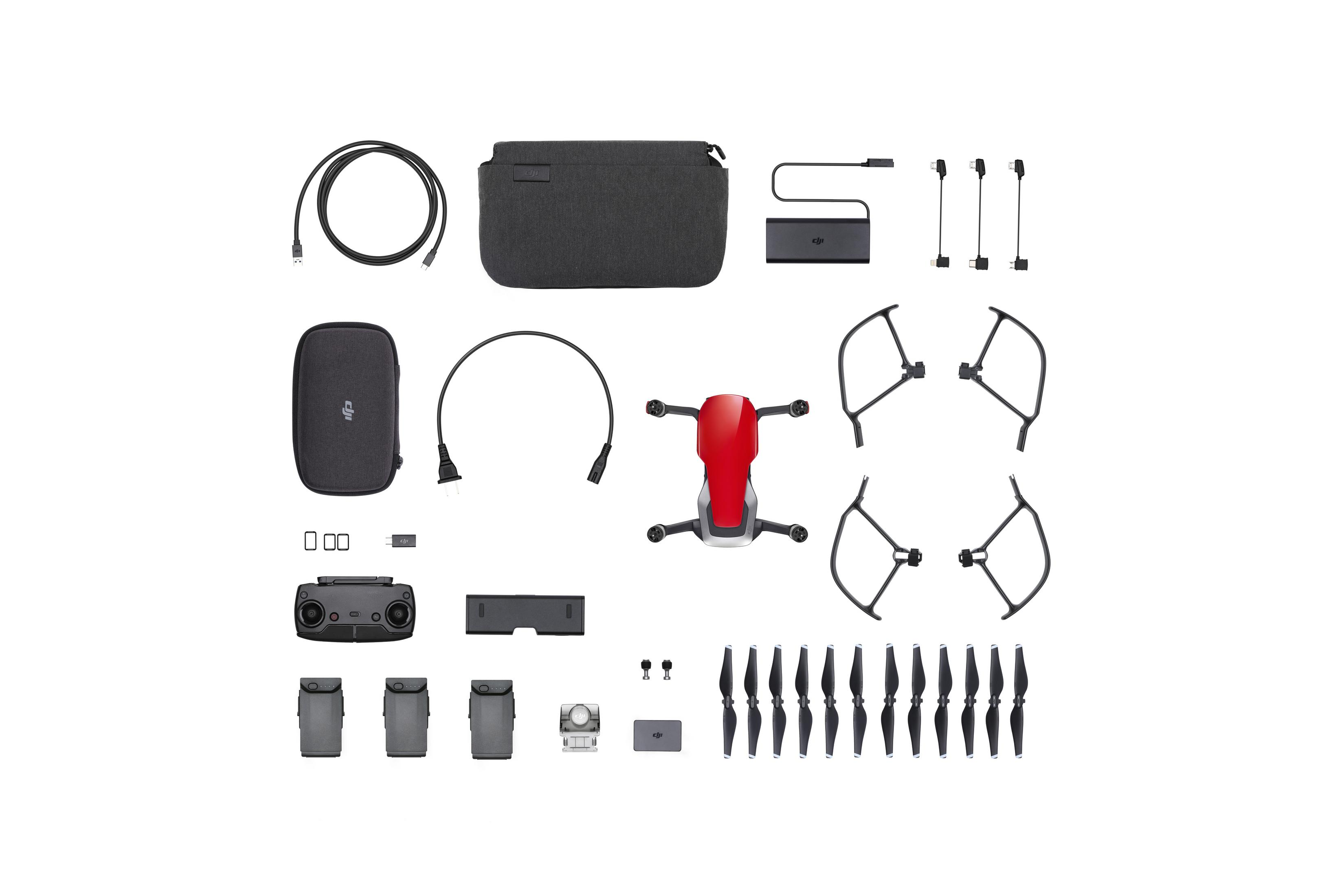 Drohnen-Kit mit Drohne, Fernbedienung, Akkus, Ladegerät, Propellern, Kabeln und Tragetasche, alles ordentlich angeordnet.
