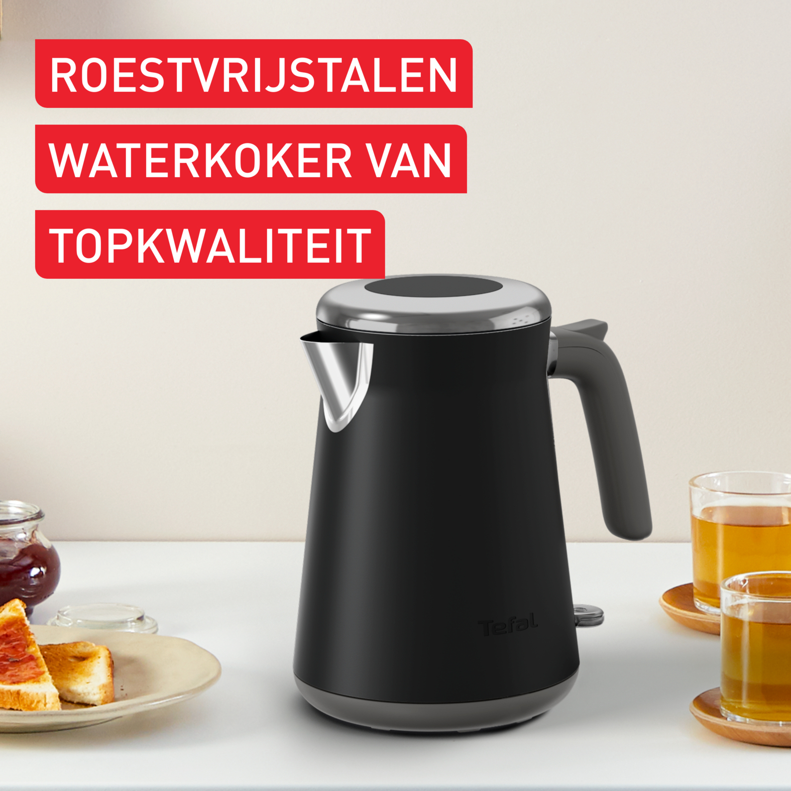 Czarny czajnik elektryczny, srebrna góra, logo Tefal, biały stół, nakładka tekstowa.