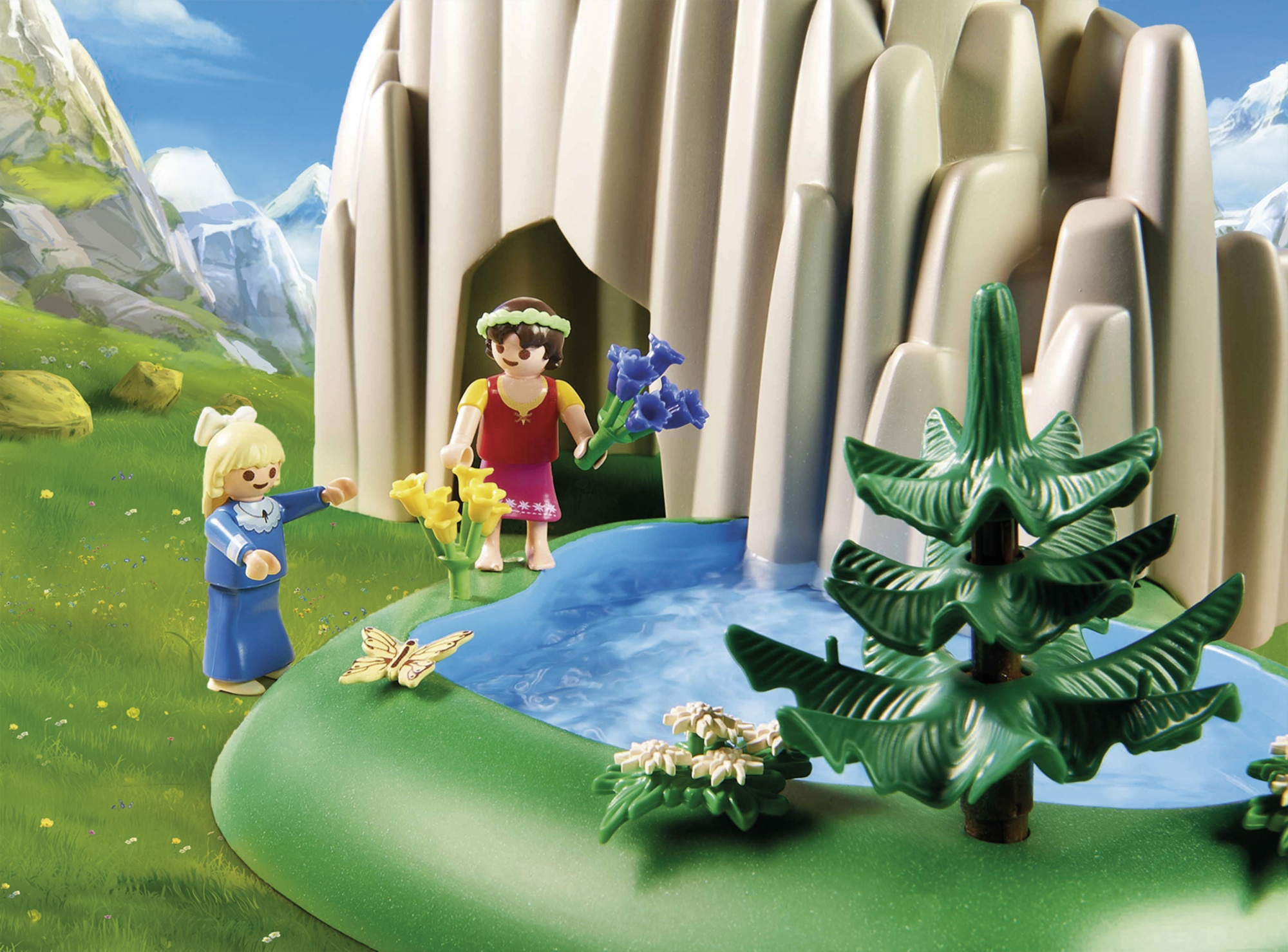 Scena Playmobil z postaciami w pobliżu stawu i wodospadu. Postacie w pobliżu drzew i jaskini.