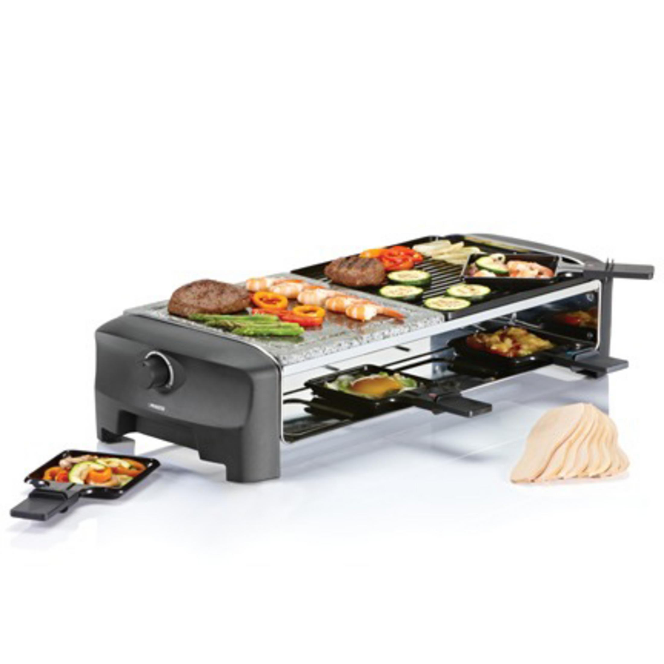 Grill do raclette z jedzeniem, w tym warzywami, mięsami i krewetkami, na kamieniu i w tackach.