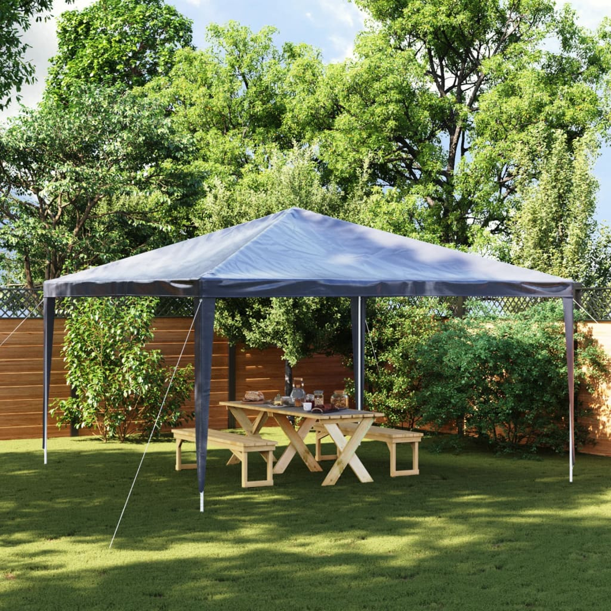 Pavillon mit Picknicktisch und Bänken auf Rasen. Bäume umgeben die Szene, Garten.