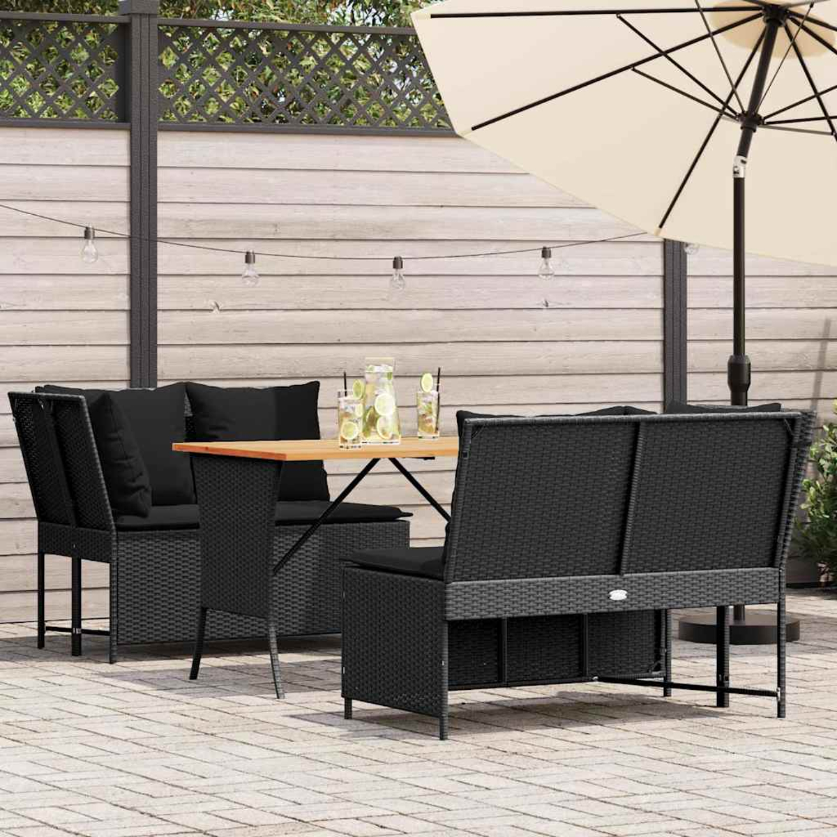 Un set da patio in rattan nero con tavolo, sedie e ombrellone in un cortile.