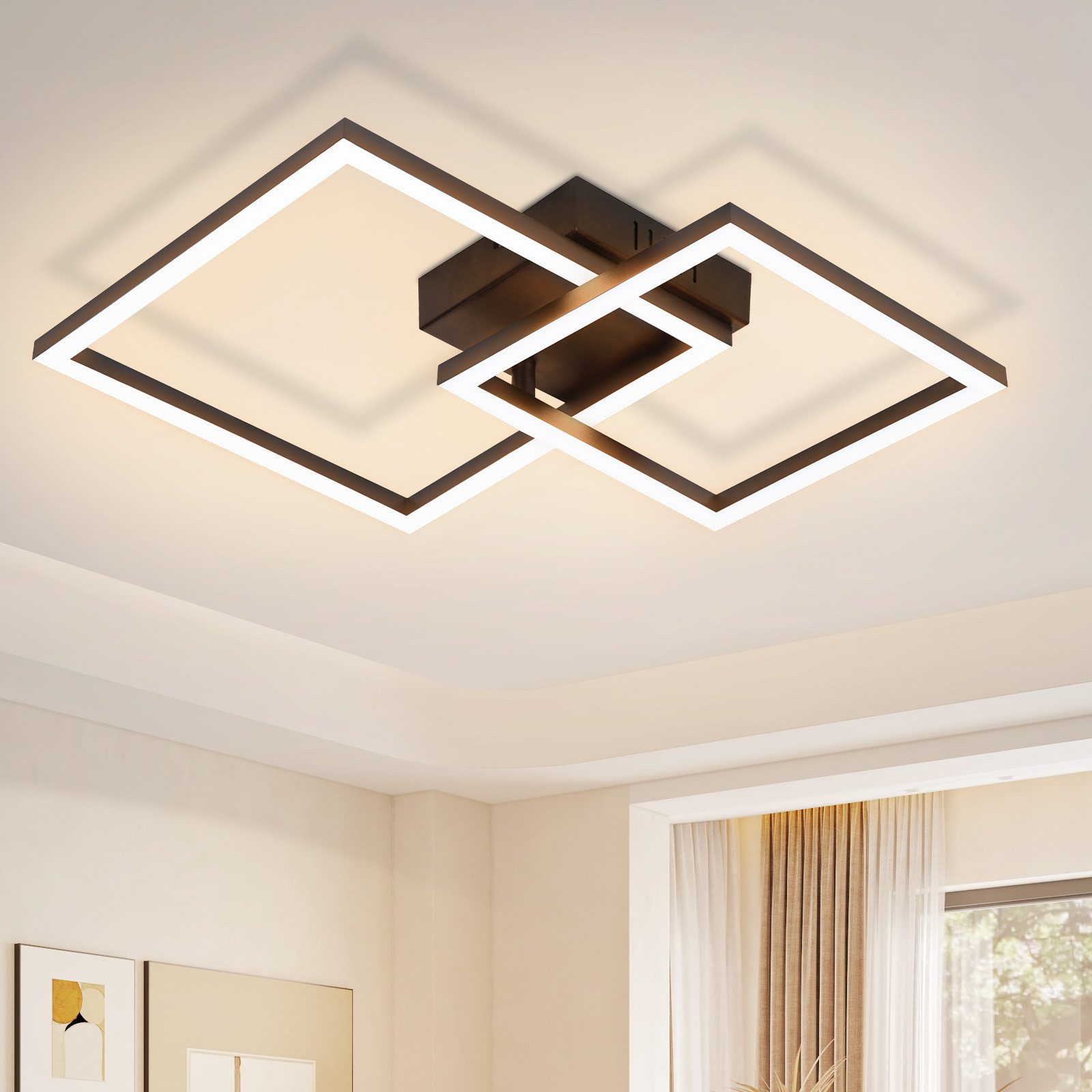 Lampada da soffitto moderna con due cornici quadrate intersecanti, su un soffitto bianco, con illuminazione soffusa.