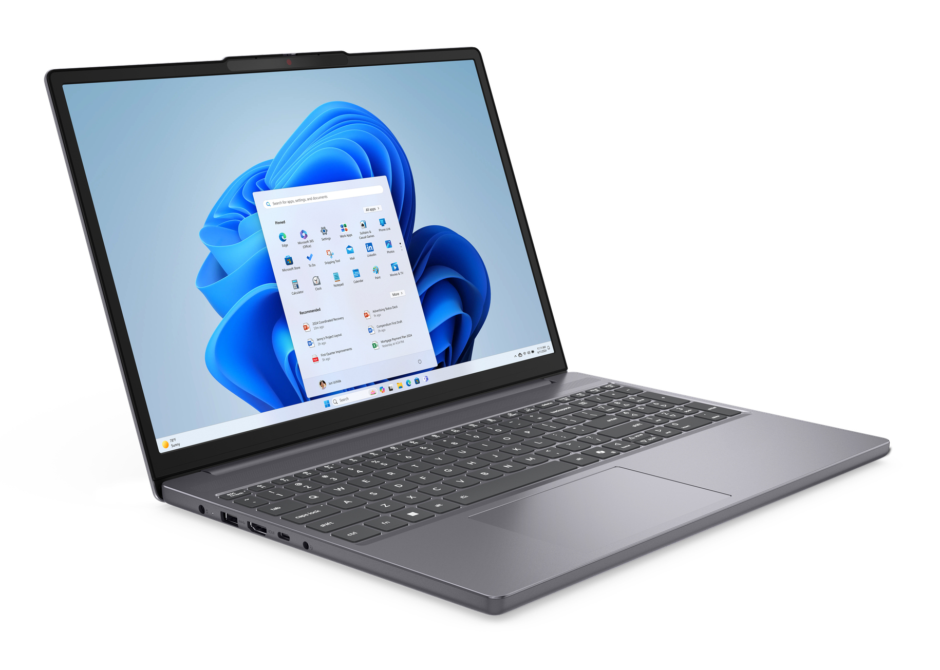 Windows 11 arayüzü açık dizüstü bilgisayar. Gri gövde, siyah klavye, beyaz arka plan.