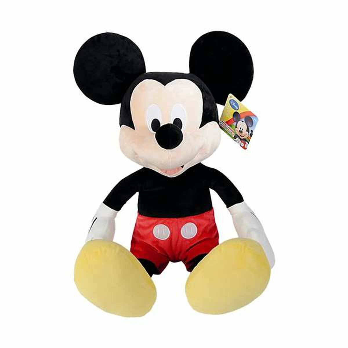 Peluche de Mickey Mouse, sentado. Ropa negra y roja, zapatos amarillos. Fondo blanco.