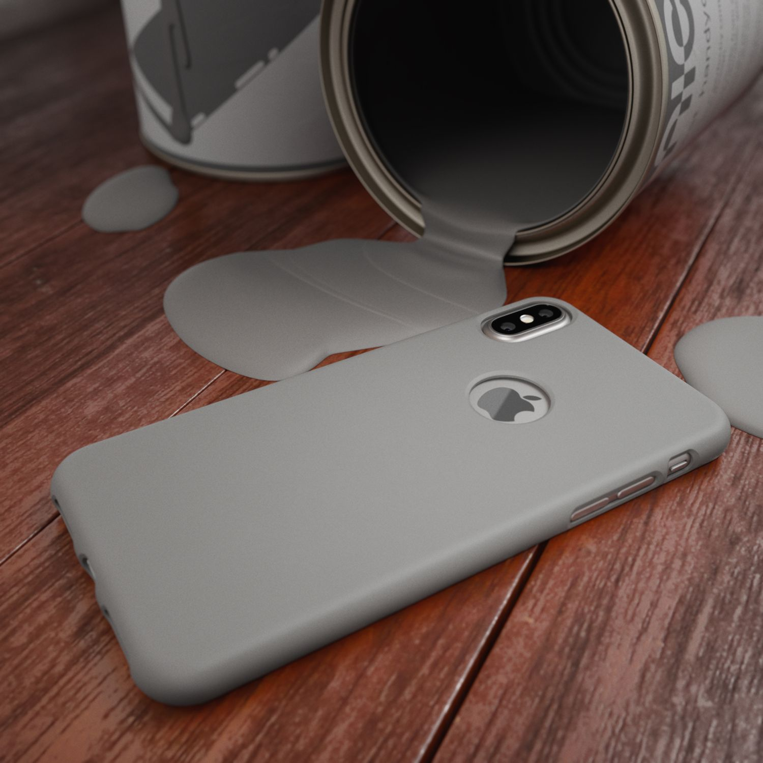 Una custodia grigia per telefono accanto a una latta di vernice grigia con vernice versata su una superficie di legno. Visibile un logo Apple.