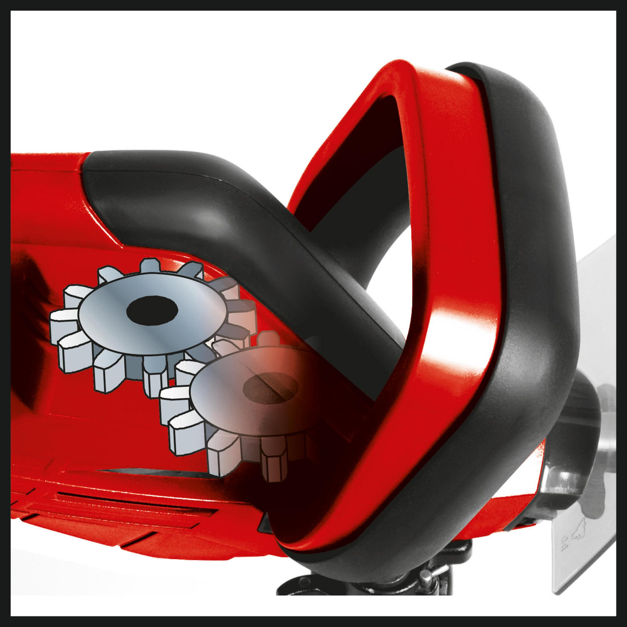 Zbliżenie czerwono-czarnego elektronarzędzia pokazujące wewnętrzne koła zębate i uchwyt.