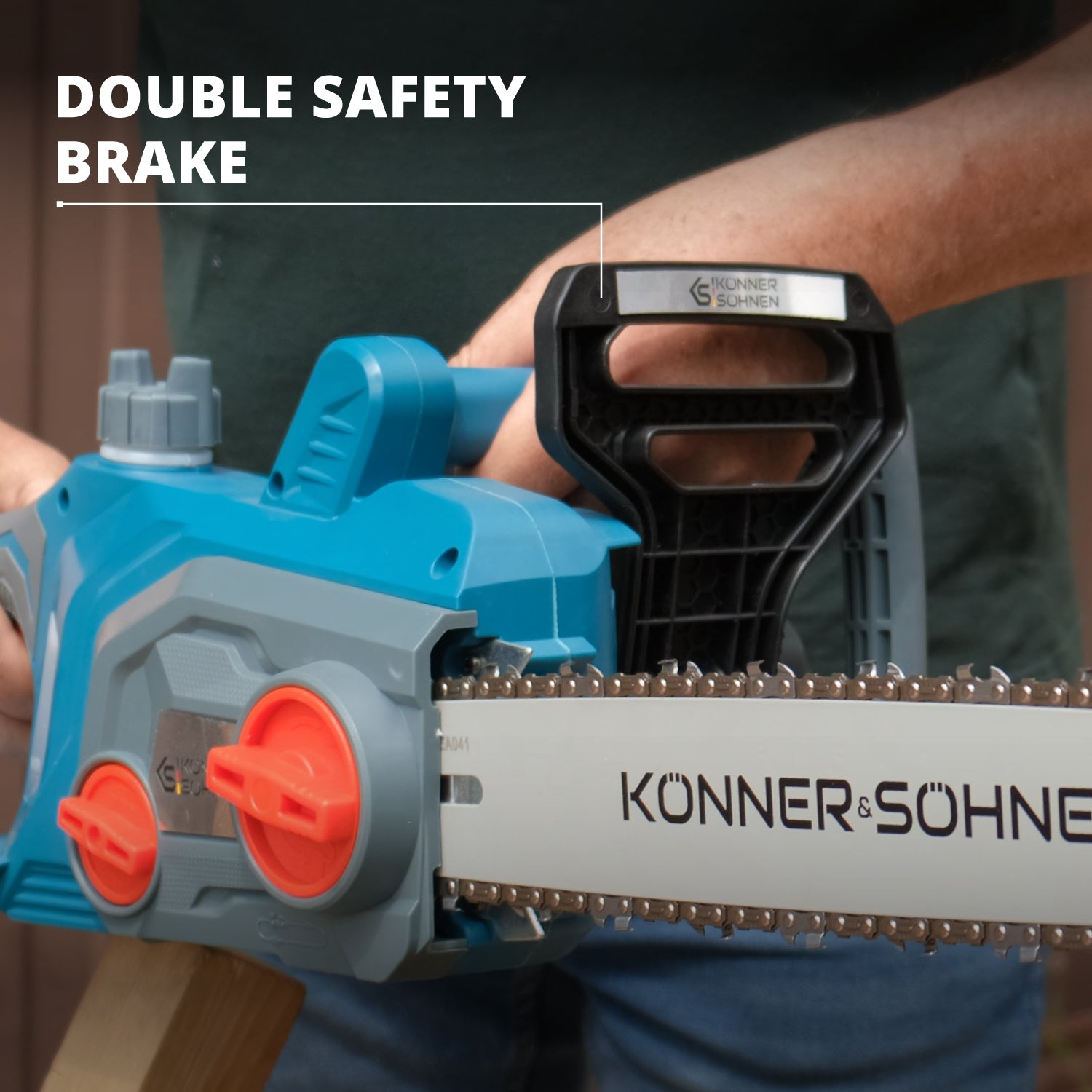 Niebieska piła łańcuchowa. Podwójny hamulec bezpieczeństwa. Widoczne ręce użytkownika, tnące drewno.