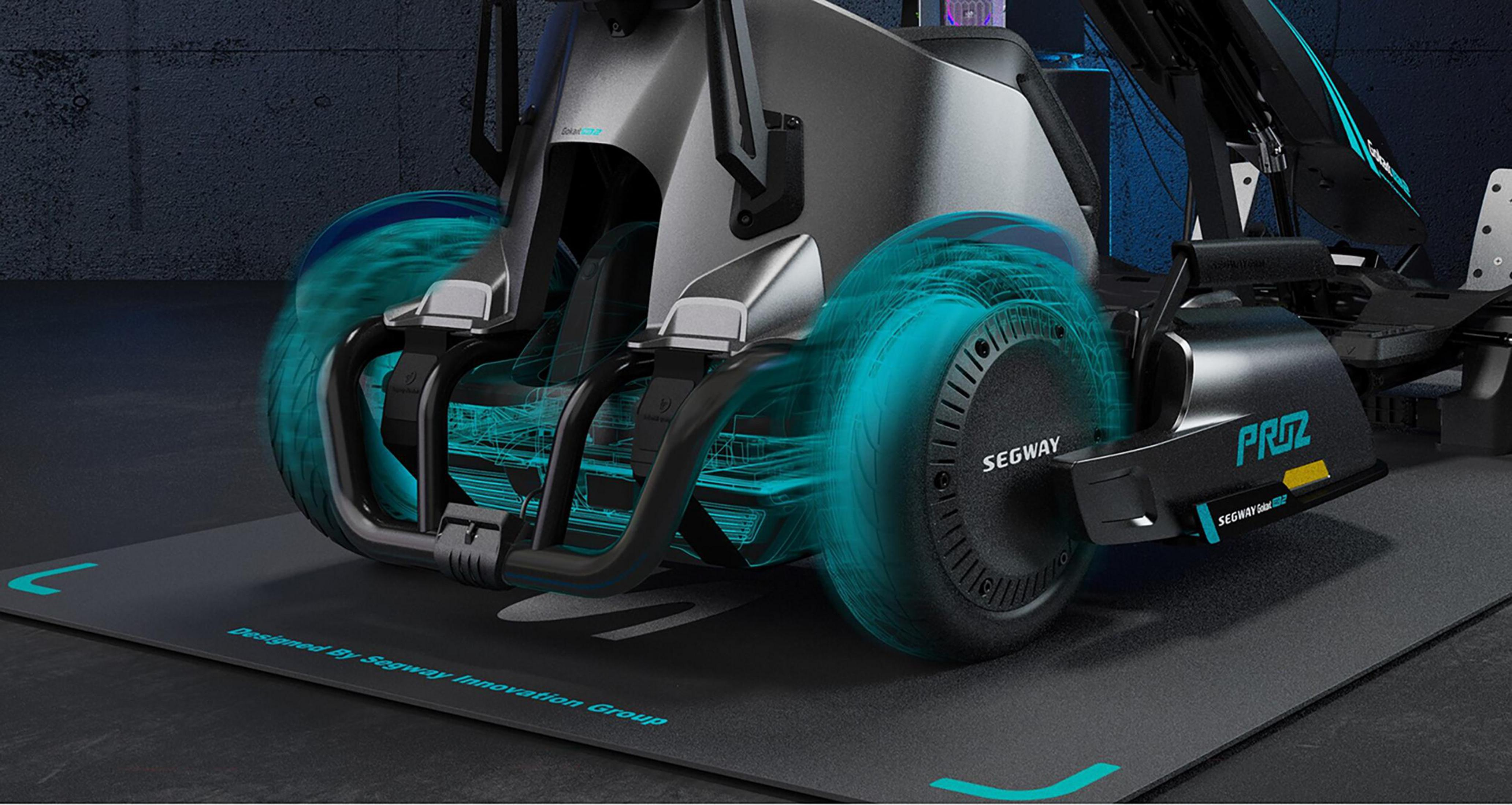 Zbliżenie kół GoKart Pro 2. Niebieski efekt świetlny wokół opon na macie. Czarny i szary korpus.