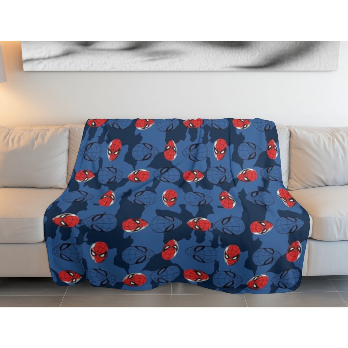 Blaue Decke mit Spider-Man-Masken und Globusmuster auf Sofa.