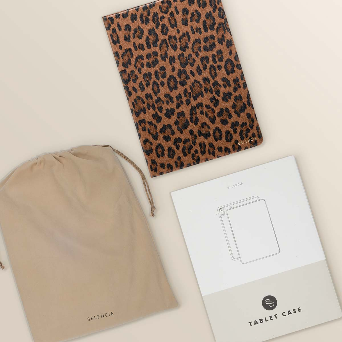 Tablet accessories: a beige bag, a tablet case, and a leaflet.