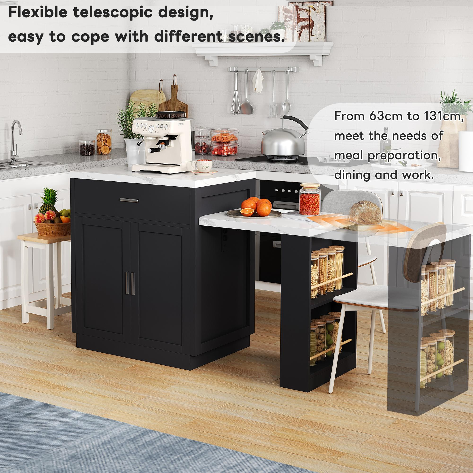 Eine Kücheninsel mit schwarzem Schrank und weißer Arbeitsplatte, mit ausziehbarem Tisch. Orangen liegen auf dem Tisch.