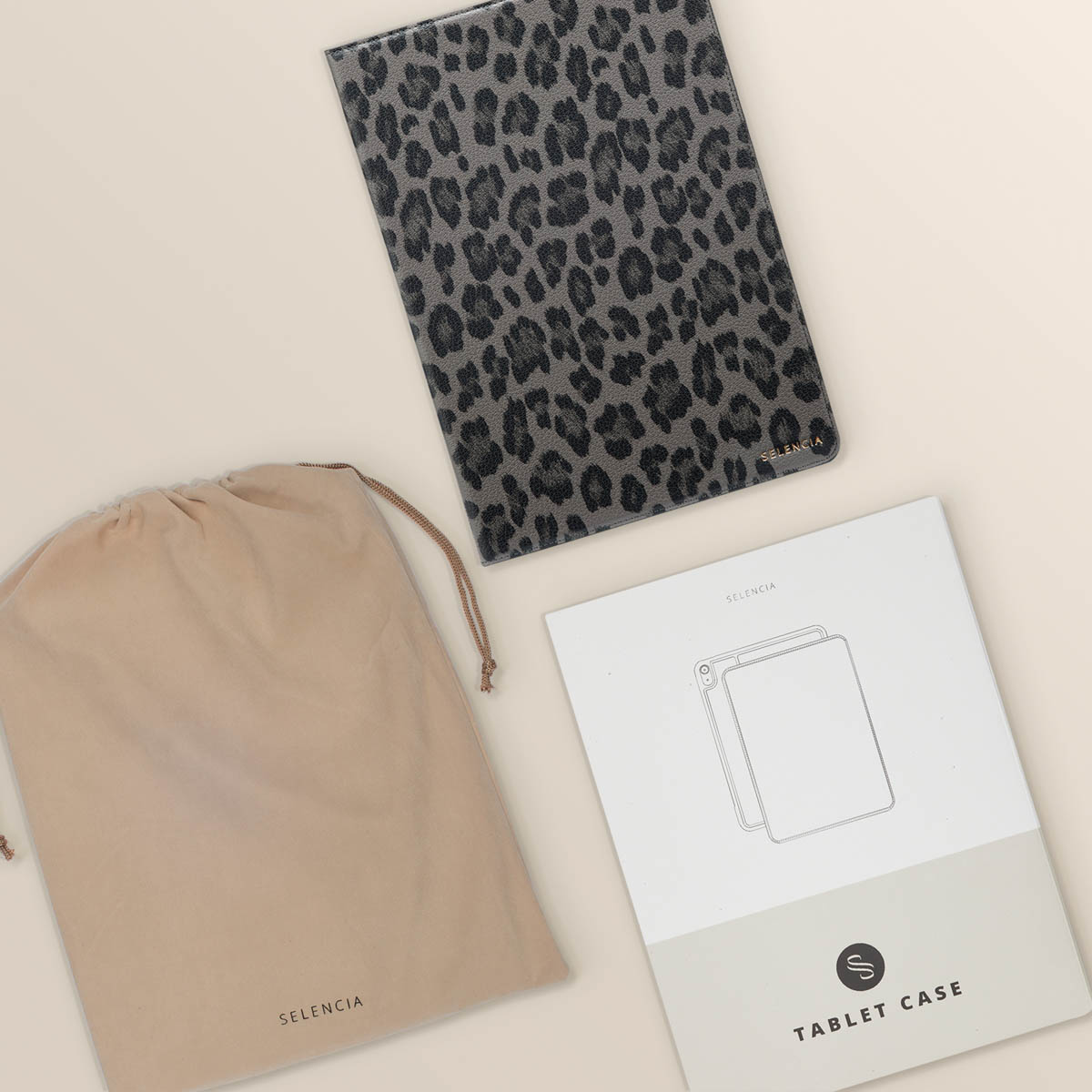 Tablet case with leopard print. A pouch and instructions are next to the case.