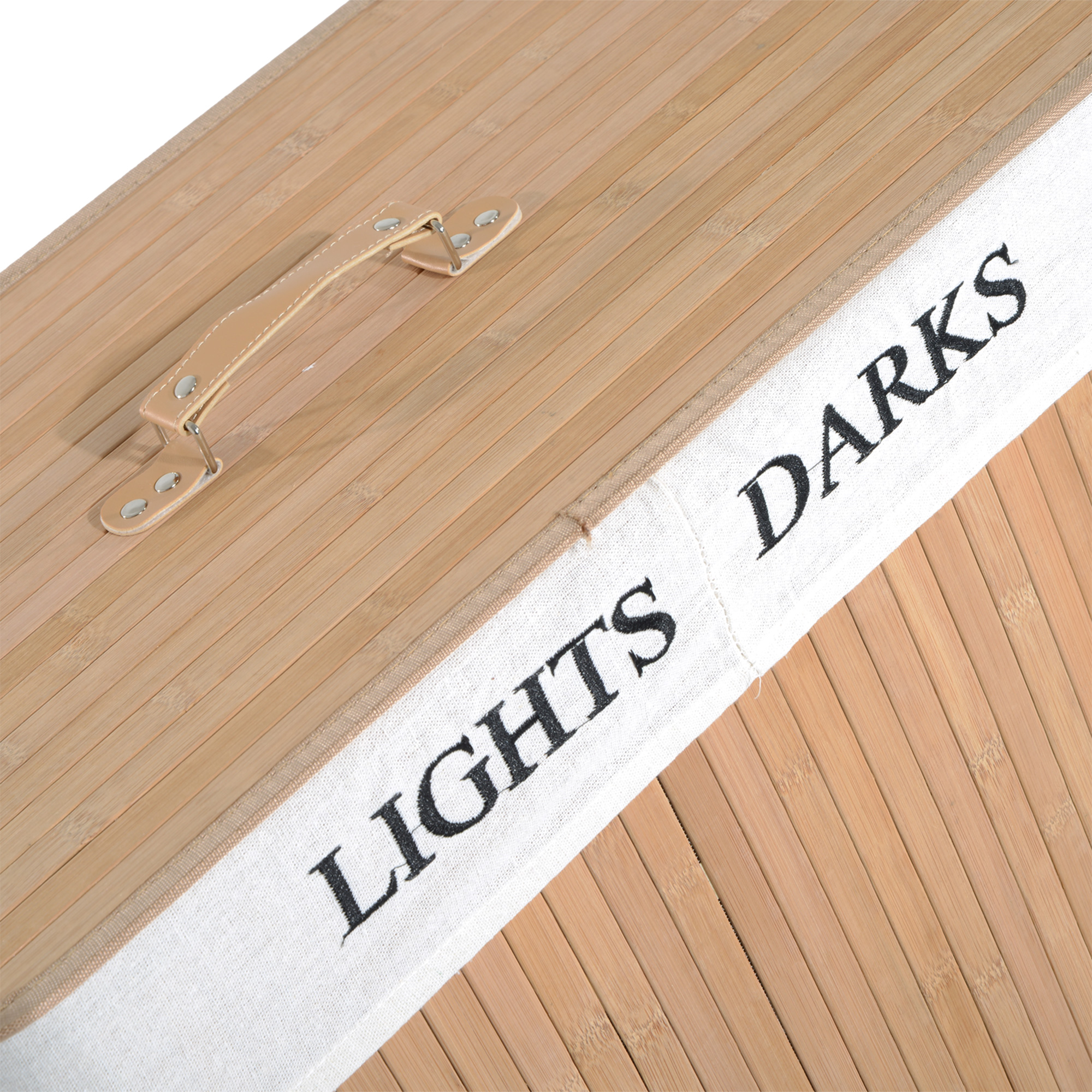 Primer plano de la tapa de una cesta de lavandería de bambú con las palabras 'LIGHTS DARKS'.