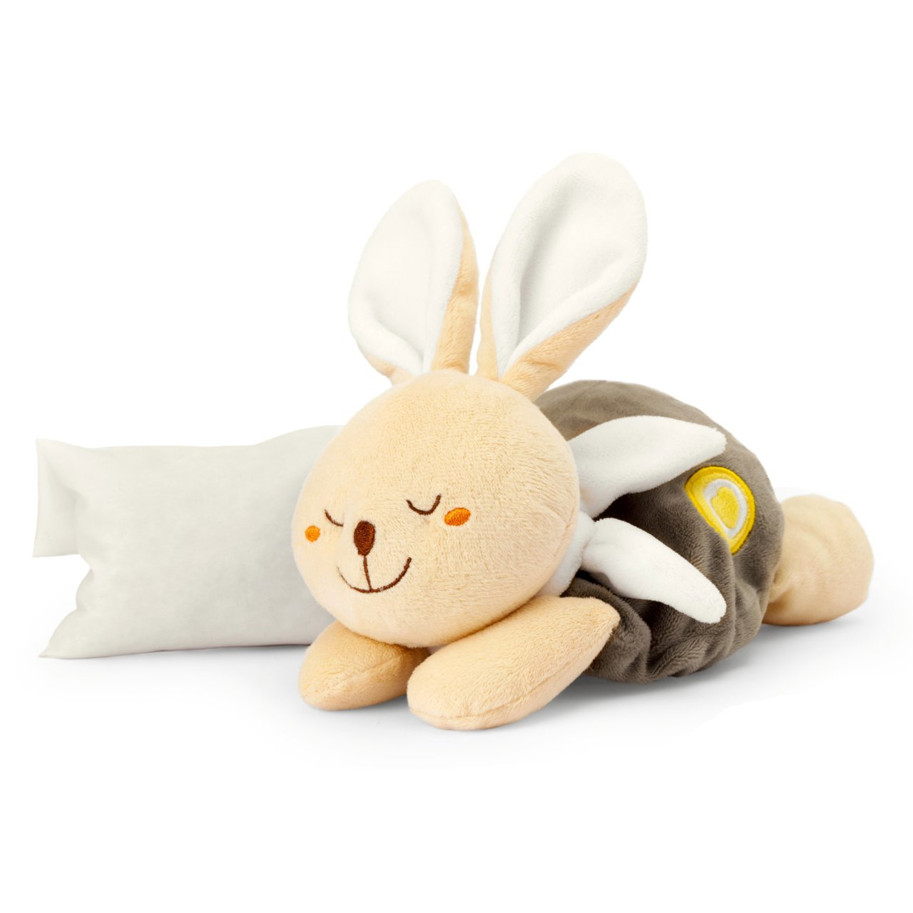 Un peluche de conejito con los ojos cerrados y una almohada blanca junto a él sobre blanco.