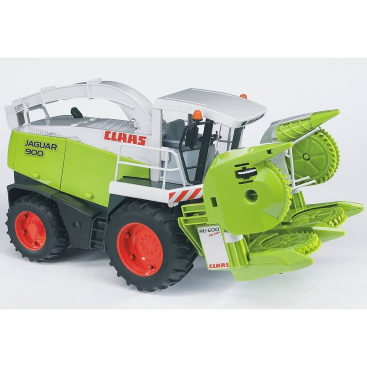 Zabawka Claas Jaguar 900. Zielono-biały korpus, czerwone koła i białe tło.