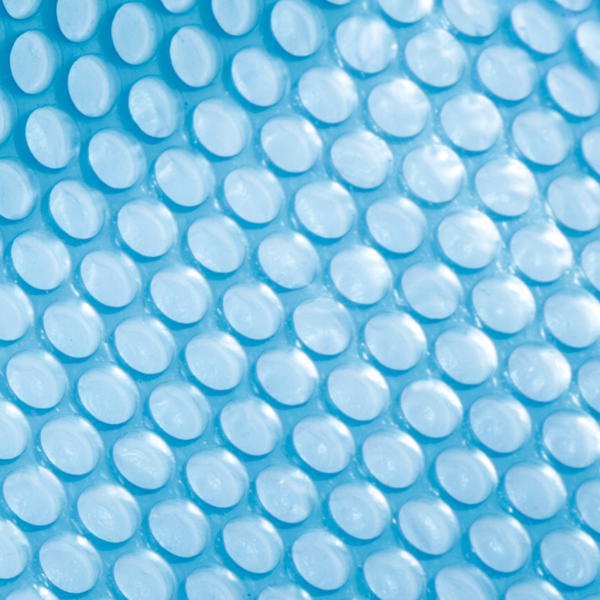Nahaufnahme einer blauen Poolabdeckung mit kleinen, kreisförmigen Luftblasen. Hellblauer Hintergrund.