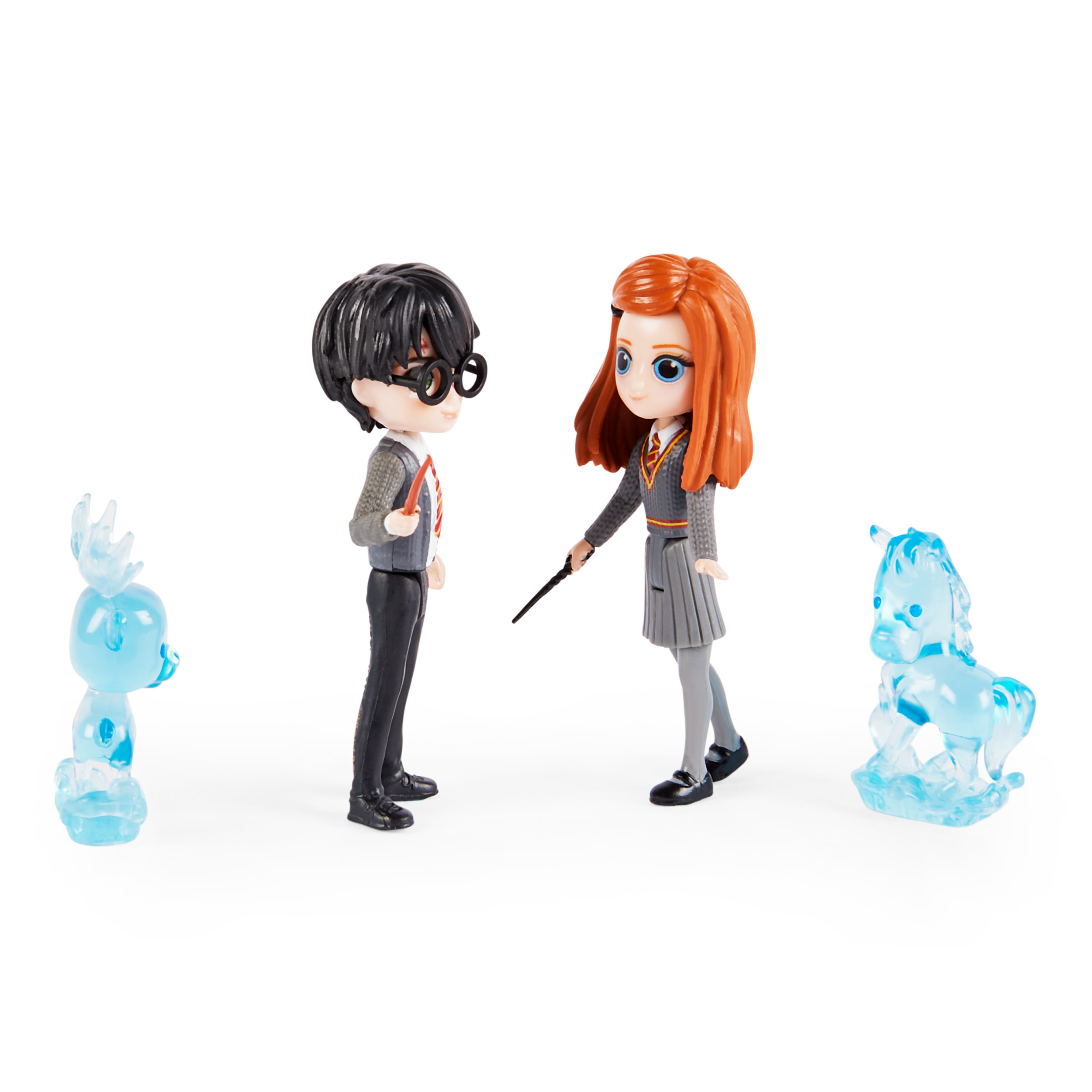 Figurki Harry'ego Pottera i Ginny Weasley z niebieskimi kryształowymi stworzeniami na białej powierzchni.