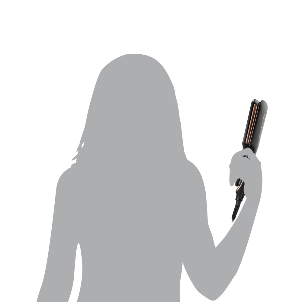 Sylwetka osoby trzymającej czarno-złotą prostownicę do włosów na białym tle.