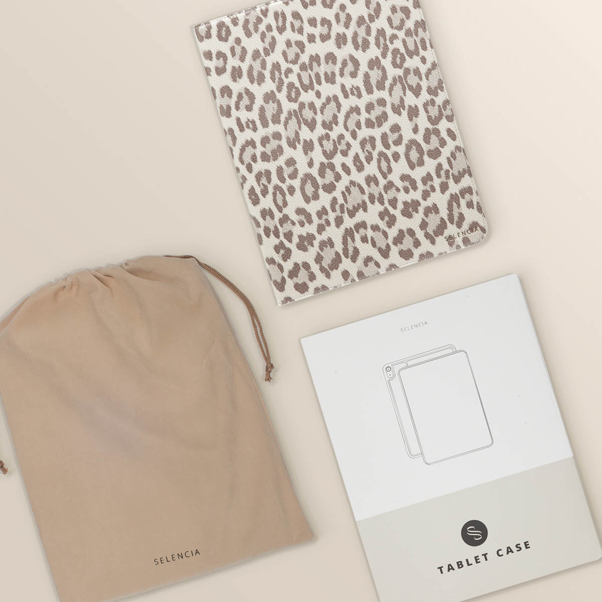 Tablet case, bag, and instructions, leopard print, beige and brown, on beige.