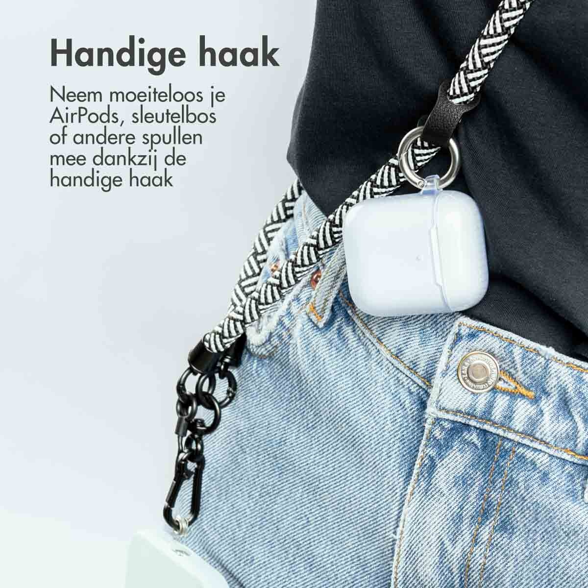 Persoon die een koord draagt met een AirPods-hoesje aan de jeans.